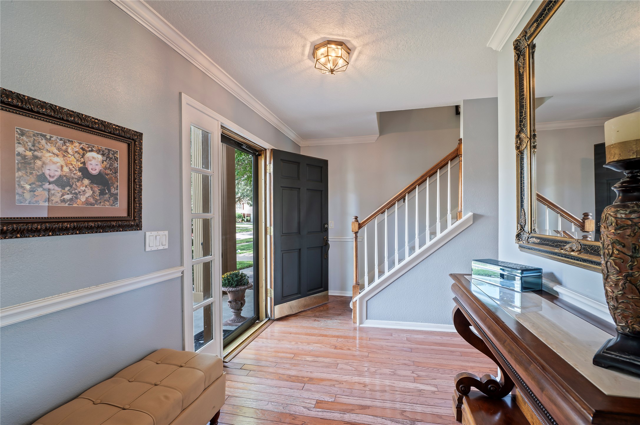 The bright foyer welcomes you with hardwood floors and a classic staircase.