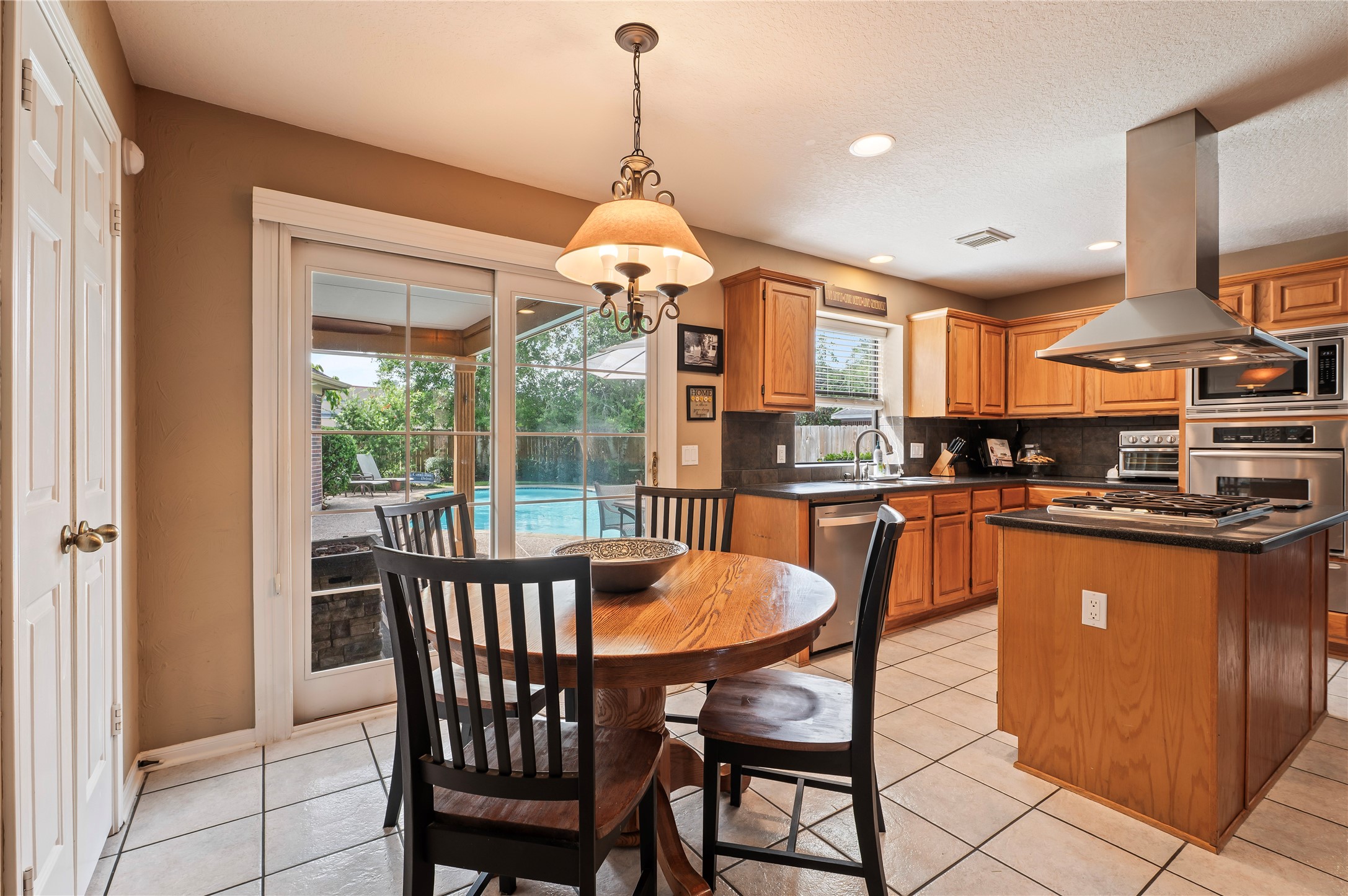 The breakfast area has a sliding glass door with a retracting blind that opens to the covered patio. Wonderful when entertaining poolside!