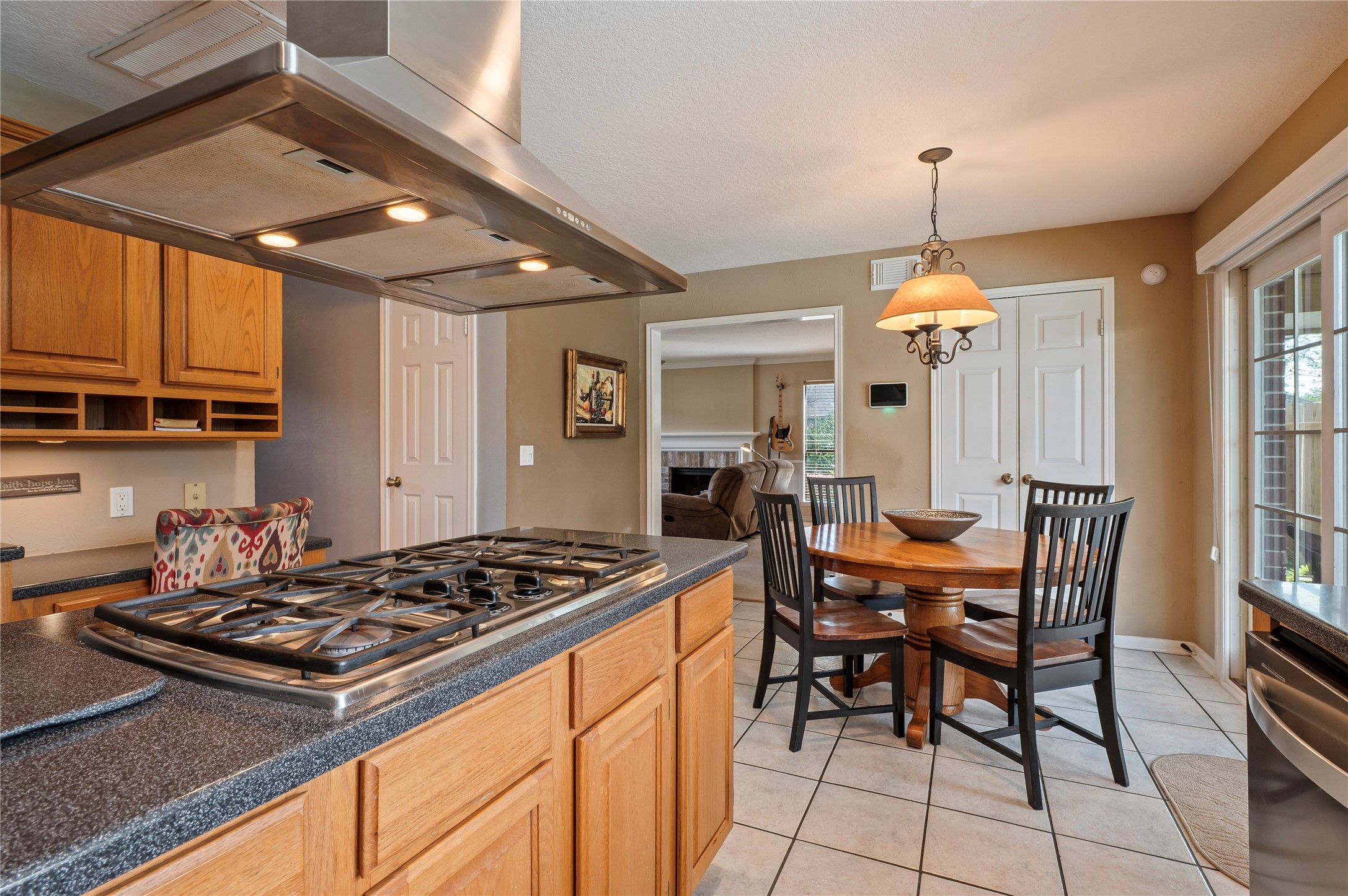 The 4-burner gas cooktop on the island looks right out to the breakfast are with plenty of space in the kitchen.