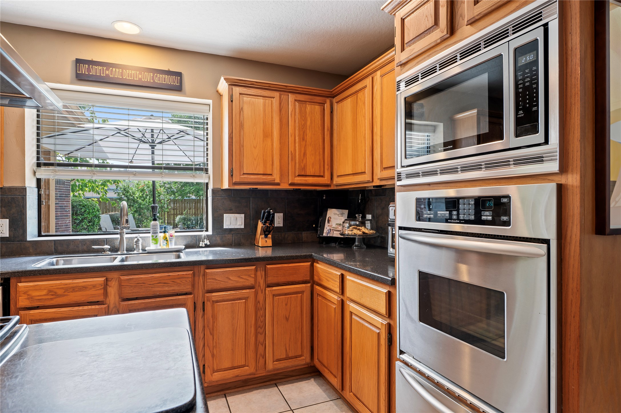 Built-in microwave, wall oven and a warming oven, plus a slate backsplash and under-cabinet lighting.