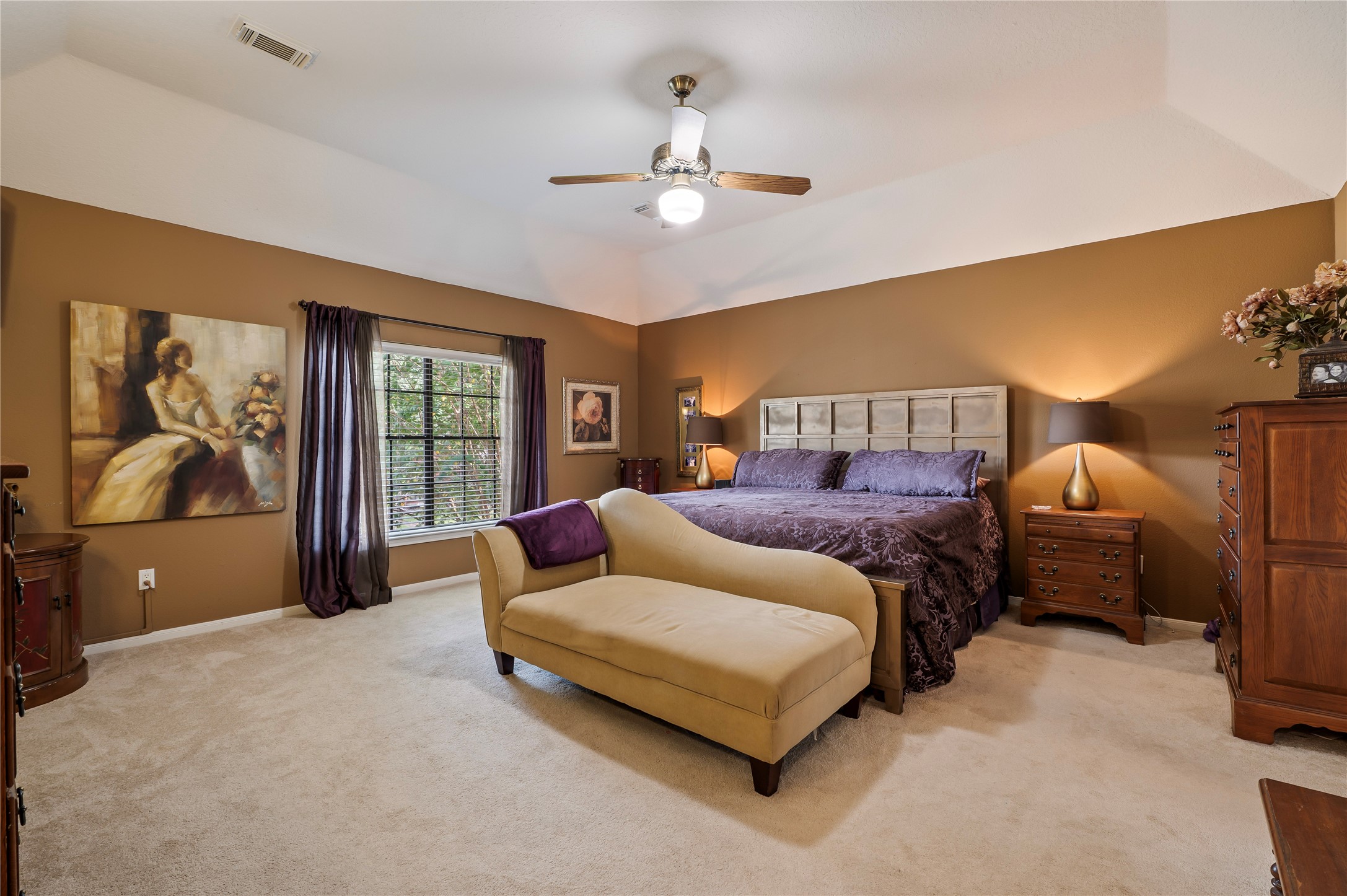The oversized primary suite is a quiet retreat with a tray ceiling and room for a sitting area.