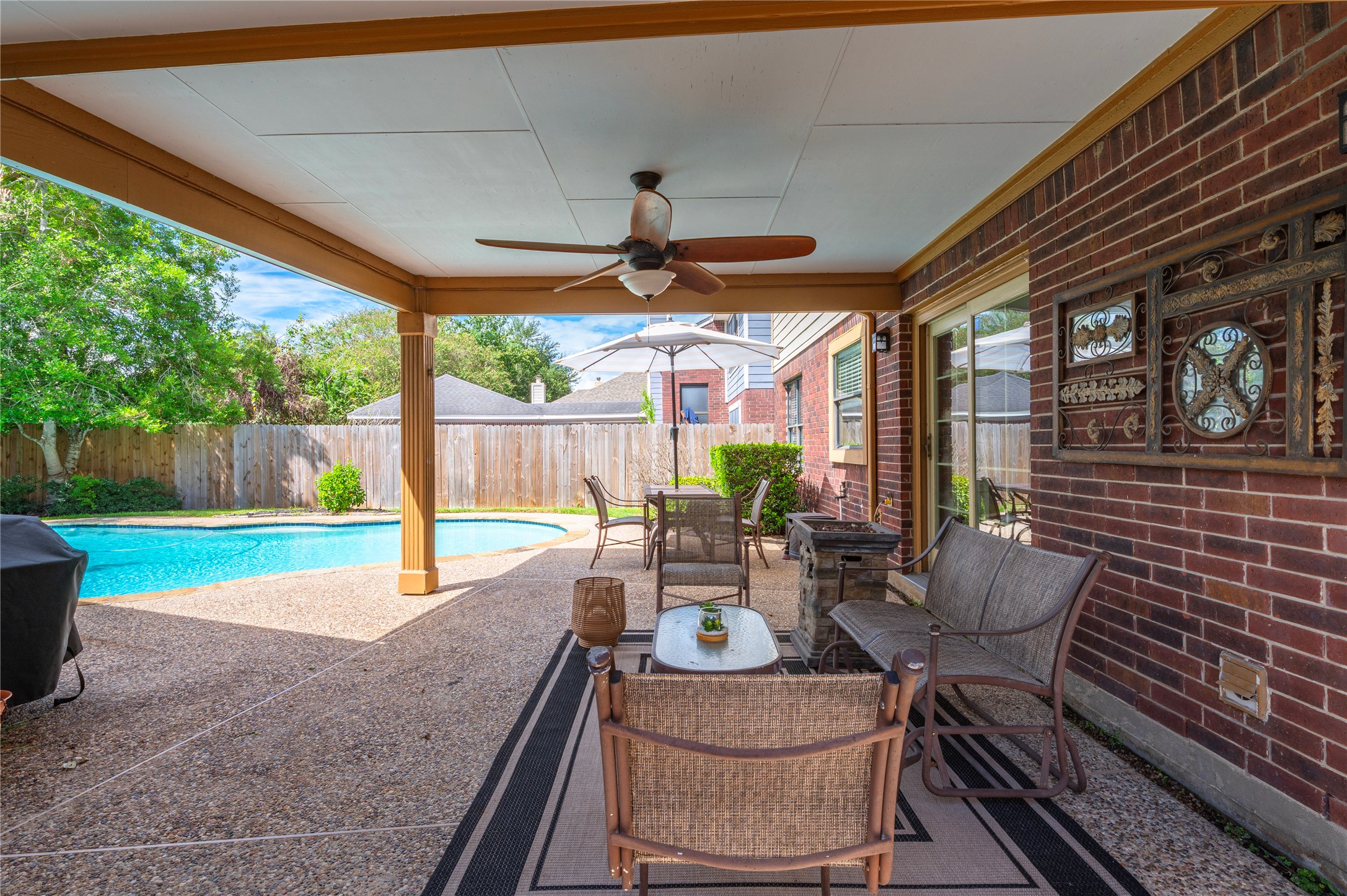 Step out to the covered back porch with ceiling fan. Perfect for morning coffee or relaxing on rainy days!