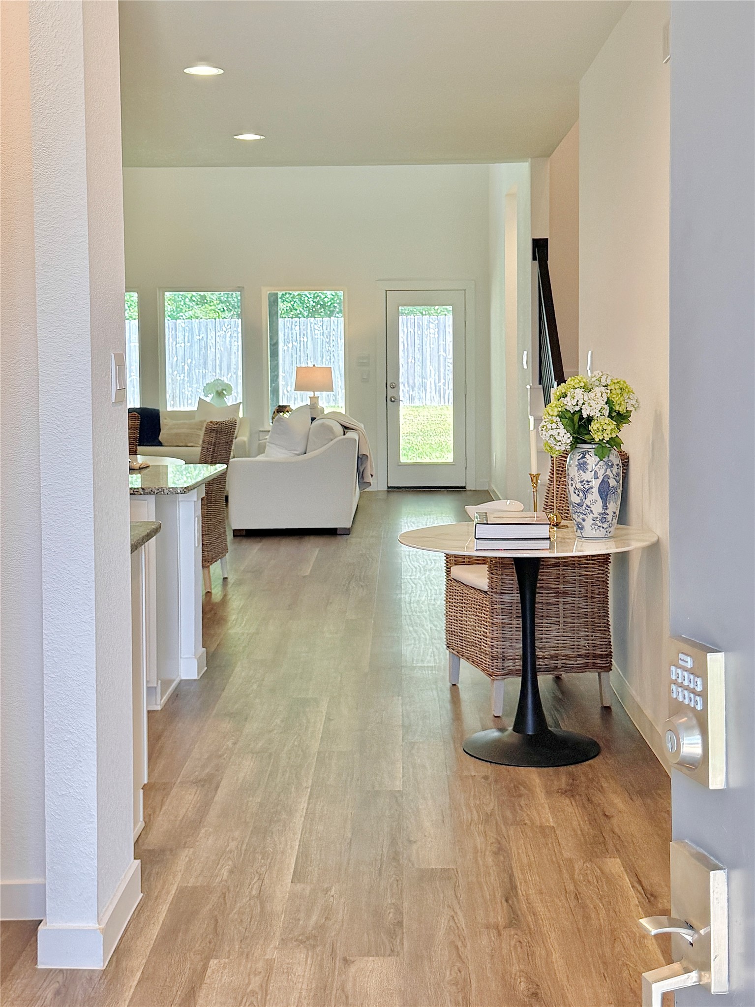 Bright and inviting open floor plan with abundant natural light from large windows overlooking the backyard.