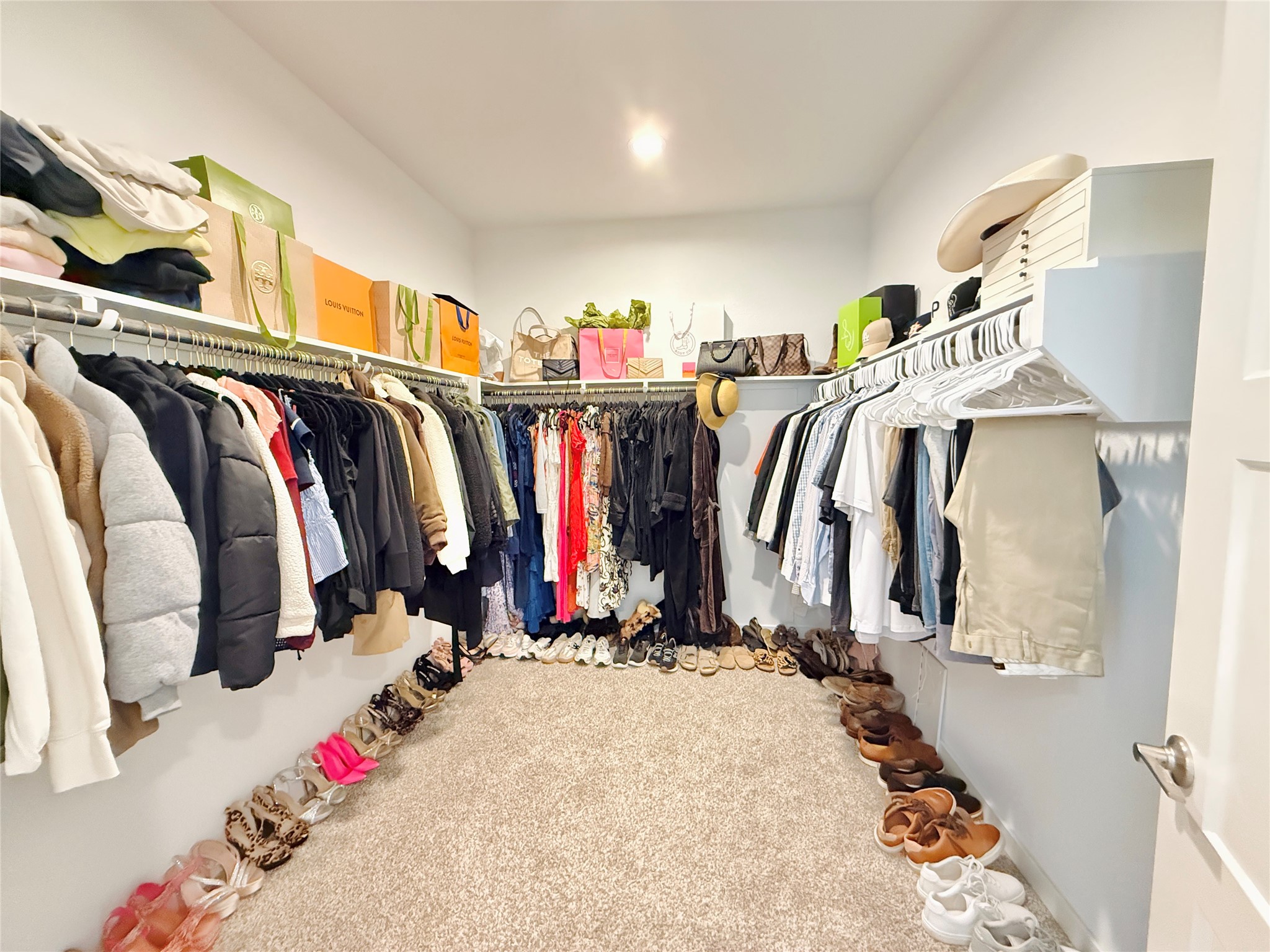 Spacious walk-in closet with ample hanging space, shelving for accessories