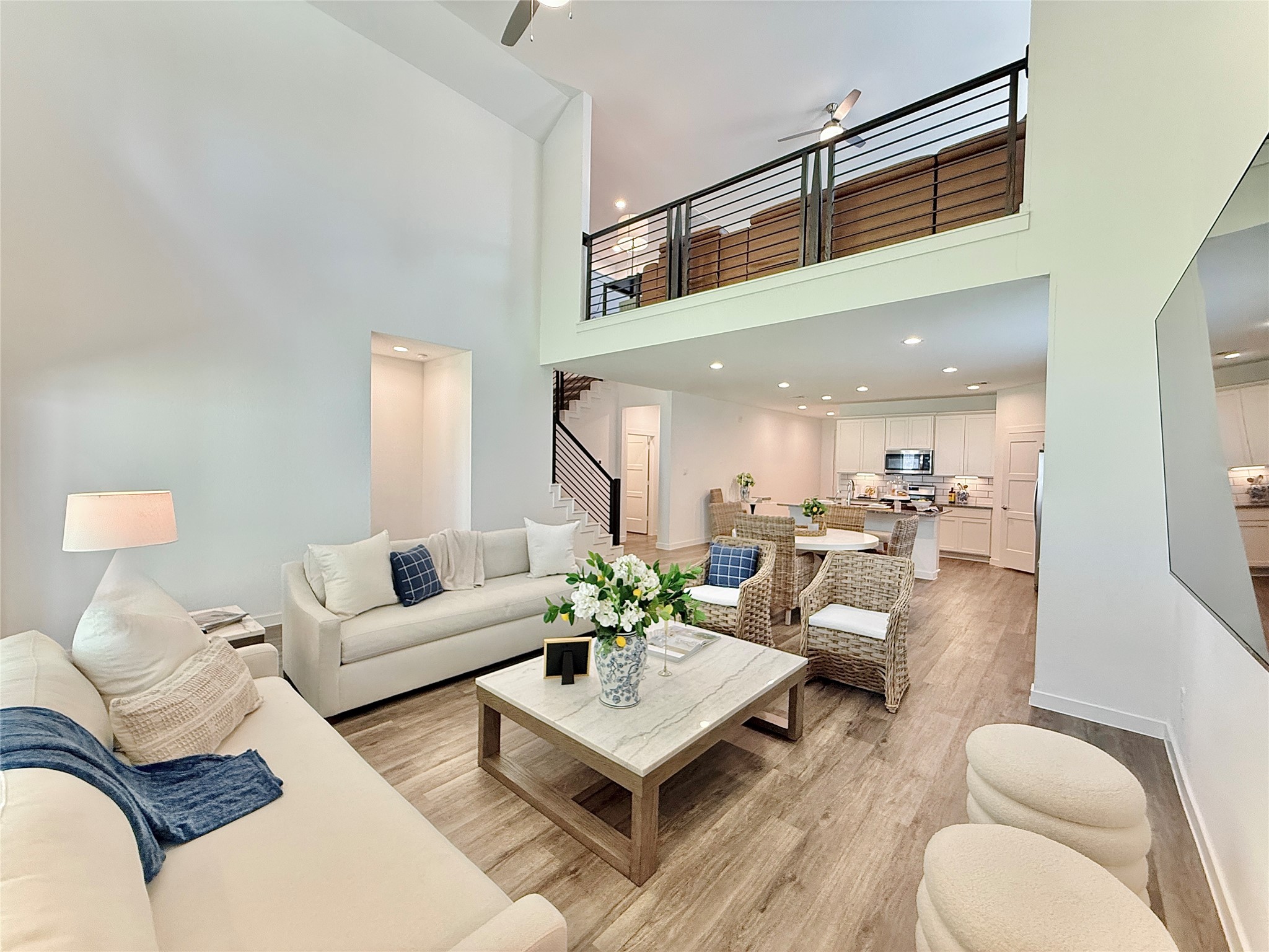 2 story living room and an open-plan layout leading to a bright kitchen, perfect for entertaining.