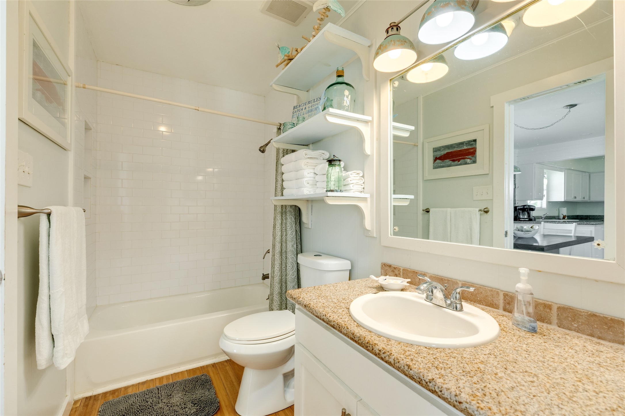 Secondary bathroom with decorative tile and granite counters.