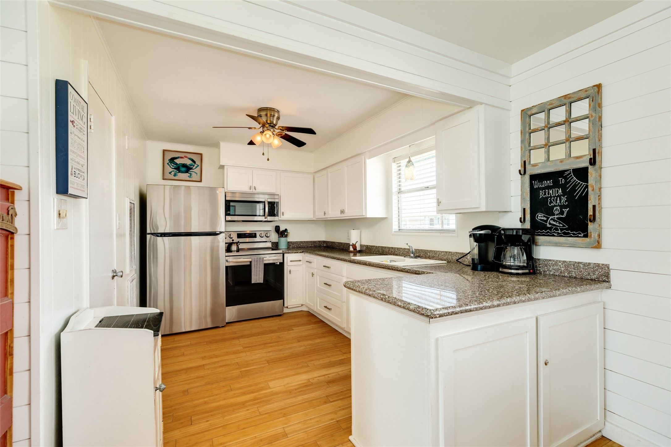 Kitchen with stainless appliances and granite counters.