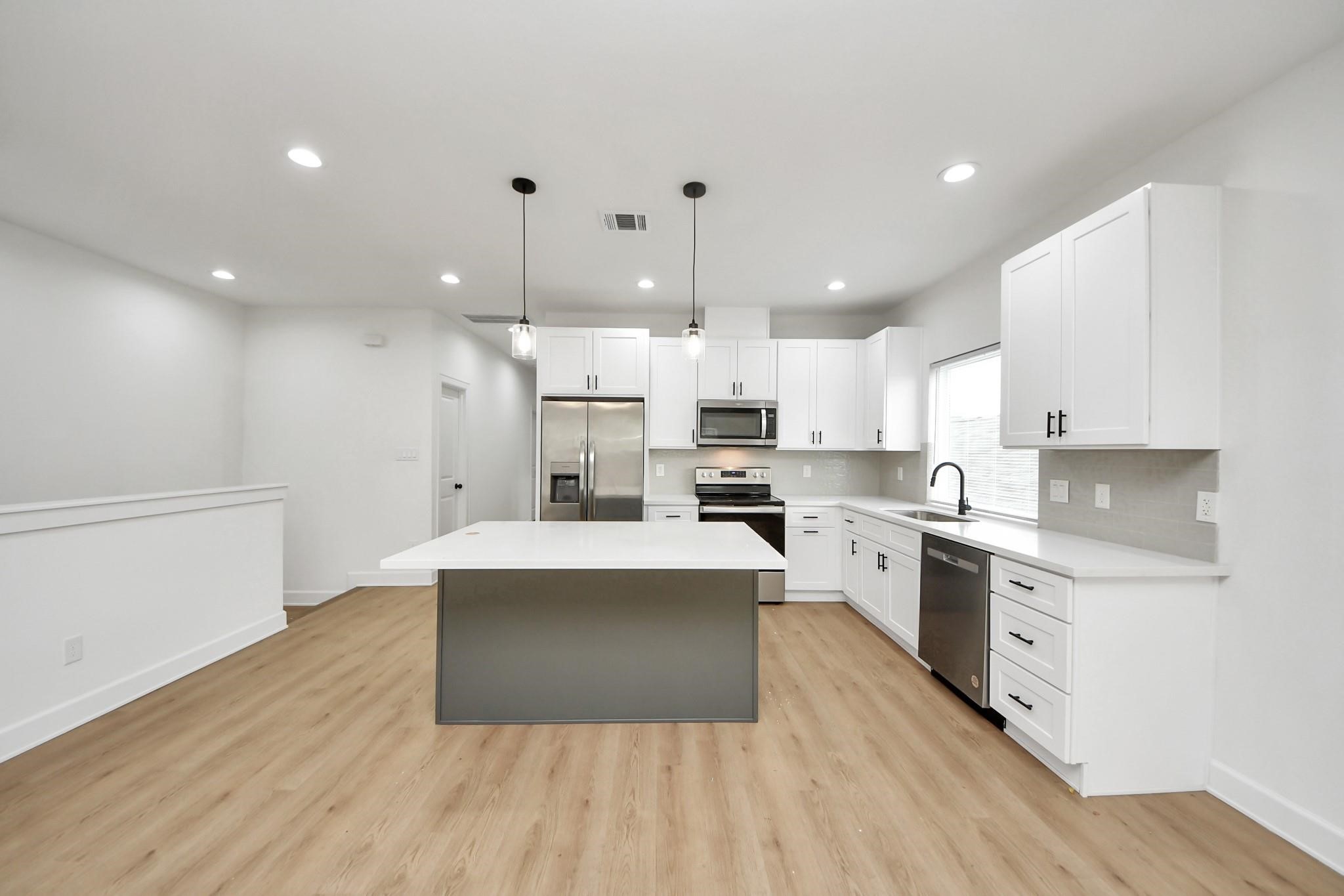 A large center island stands as the focal point of this open-concept kitchen design. A large center island stands as the focal point of this open-concept kitchen design.