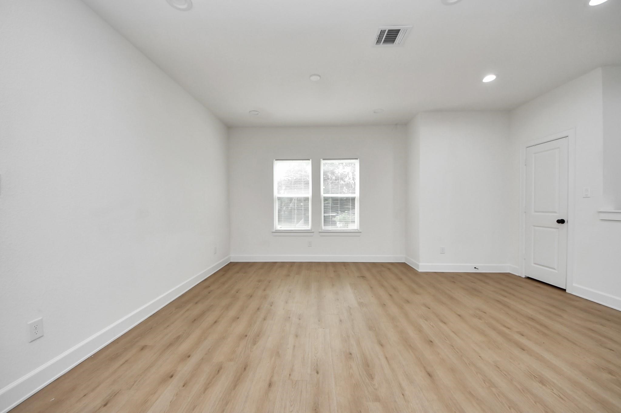 The living areas large windows invite in soft natural light and elevate the rooms clean aesthetic. The living areas large windows invite in soft natural light and elevate the rooms clean aesthetic.