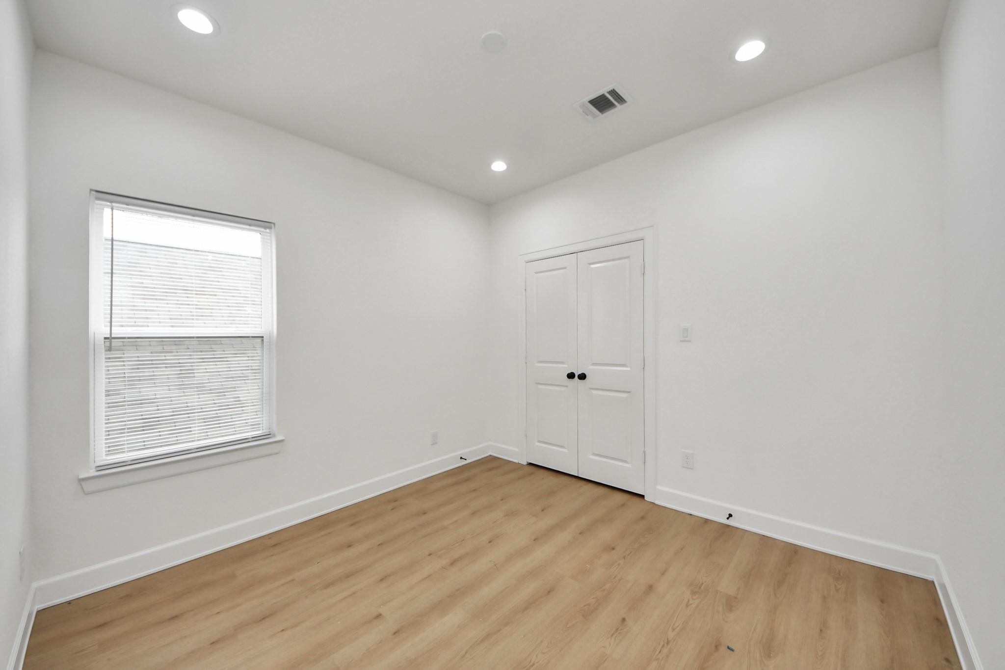 The large window brings in soft natural light, perfect for a calming bedroom or creative workspace.