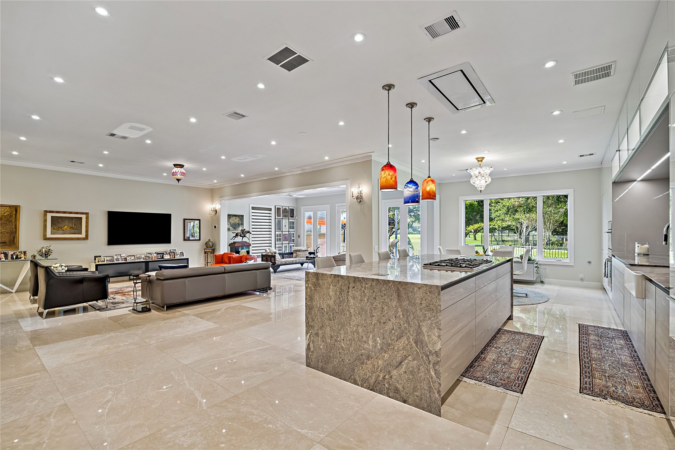 The kitchen anchors the home's main gathering spaces with an expansive island, abundant cabinetry, and an open layout. The adjoining family room offers generous space for entertaining while maintaining connection to the kitchen.