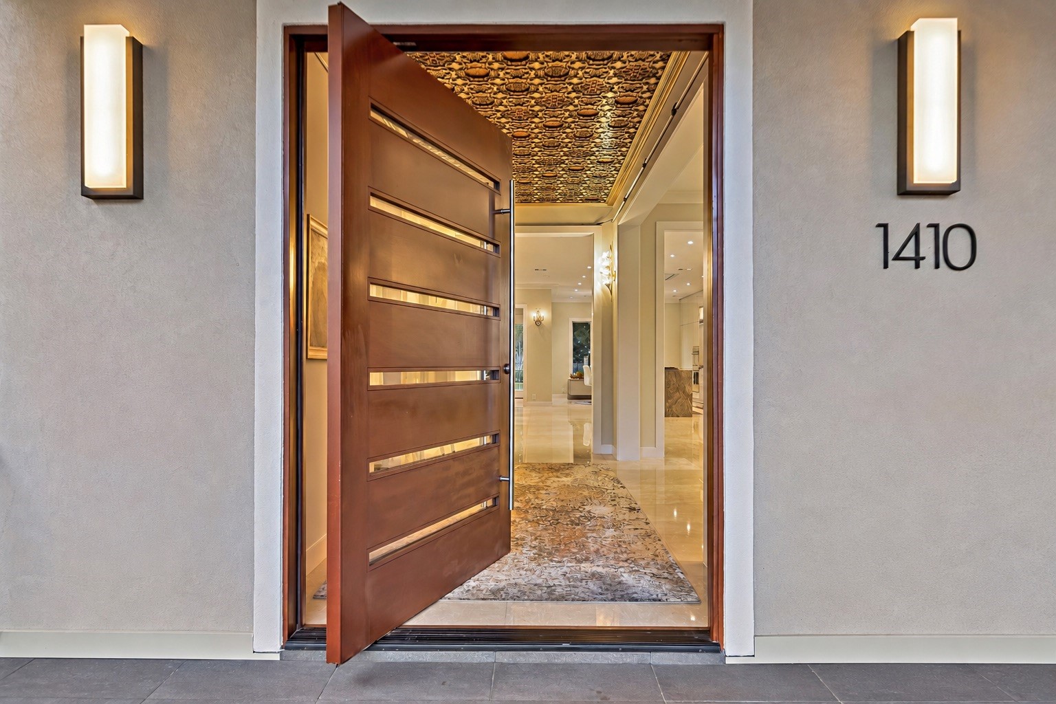 Impressive entry door welcomes guests into a residence distinguished by curated architectural details, sophisticated finishes, and an exceptional collection of Italian interiors.