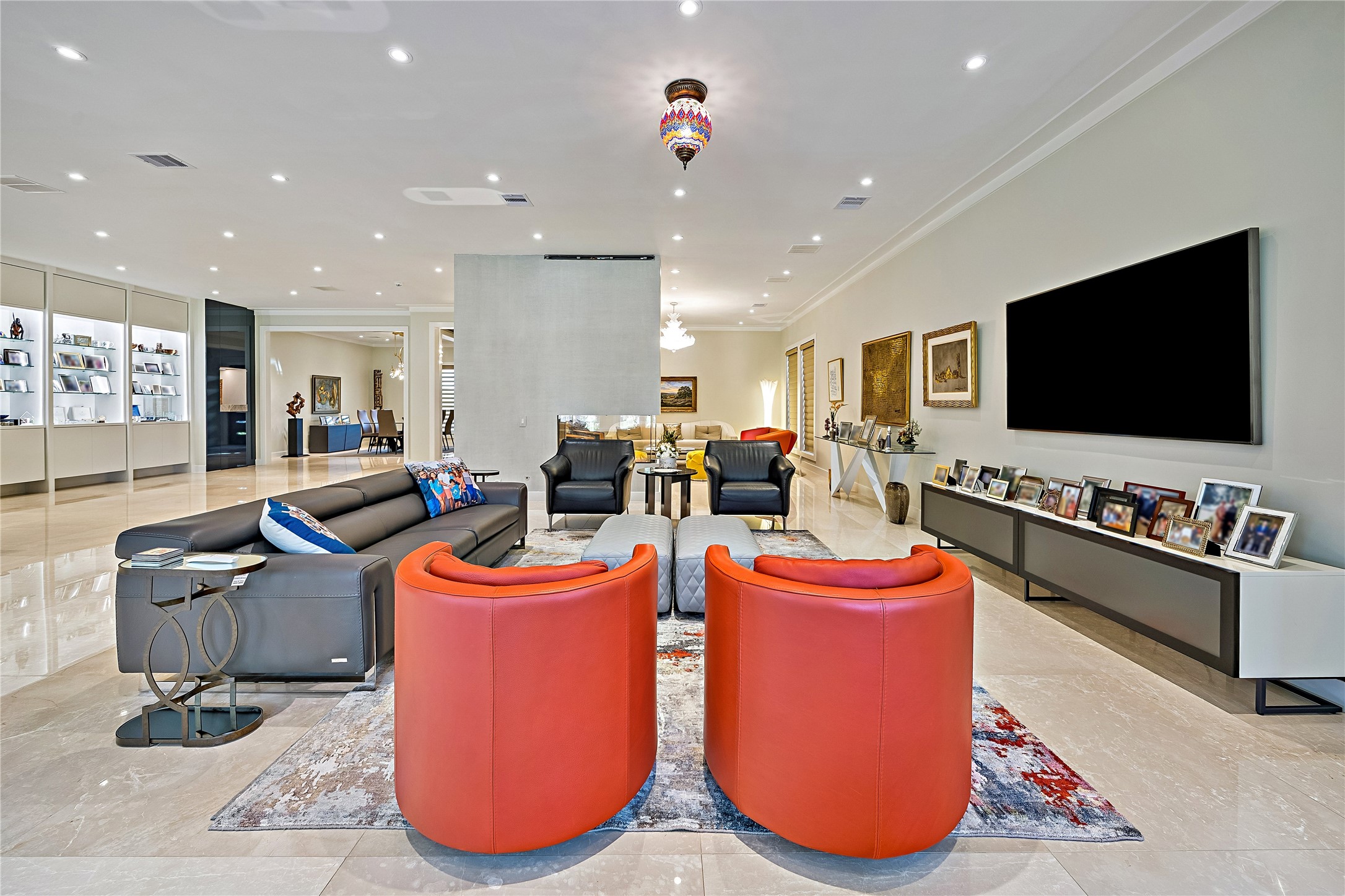 A spacious conversation lounge featuring an elegant arrangement of seating, expansive windows, and sophisticated finishes. Beautiful natural light enhances the open and welcoming atmosphere.