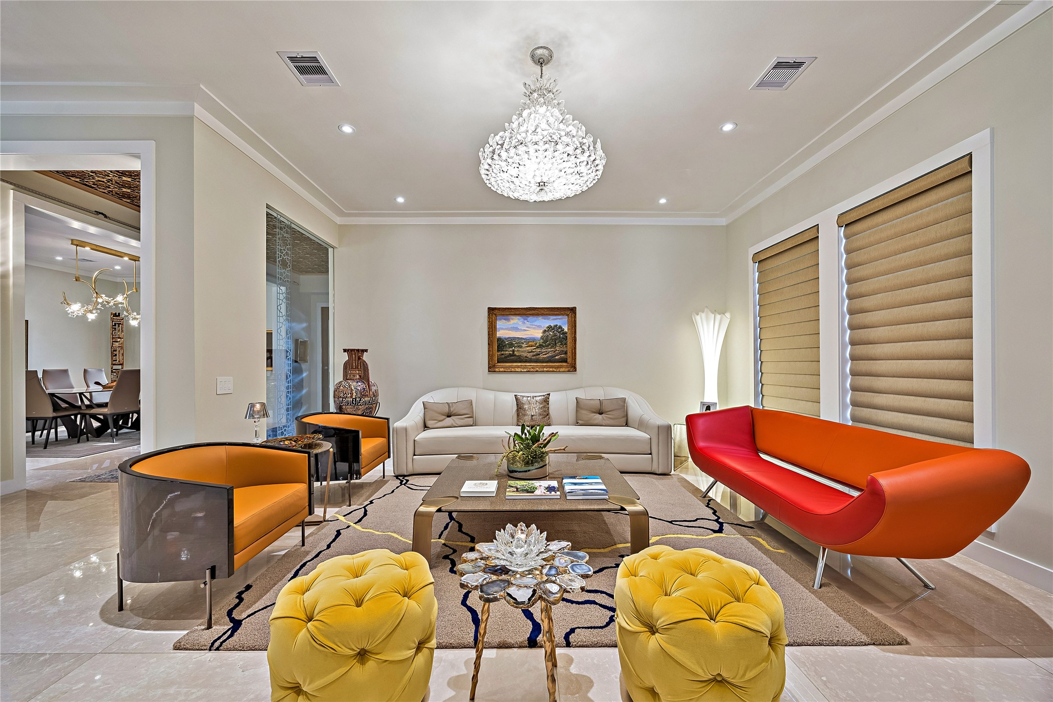 A beautiful formal living salon surrounded by expansive windows allowing natural light and views of the surrounding landscape to become part of the interior experience.
