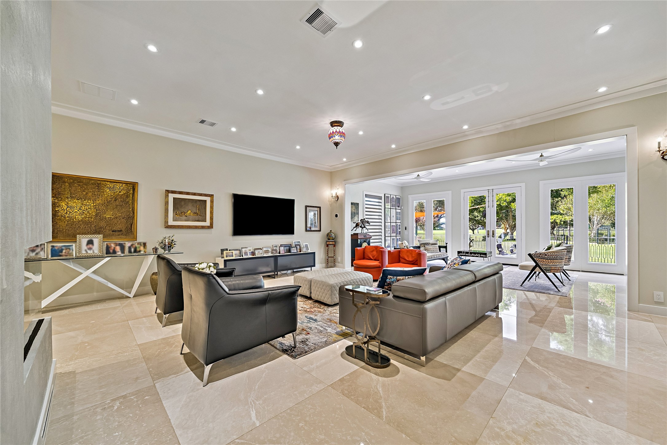 The expansive family room offers a comfortable gathering space with refined finishes, contemporary furnishings, and an open connection to the kitchen. A versatile setting for everyday living and entertaining.