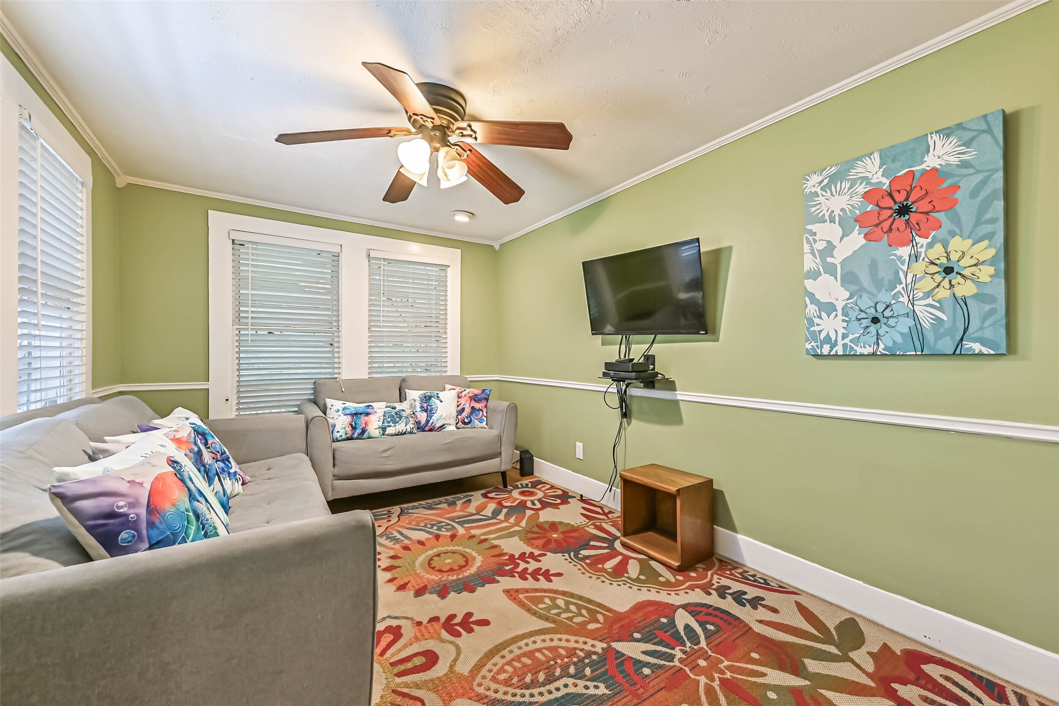 An inviting living area with comfortable sofas and a colorful area rug, offering plenty of room to relax and unwind.