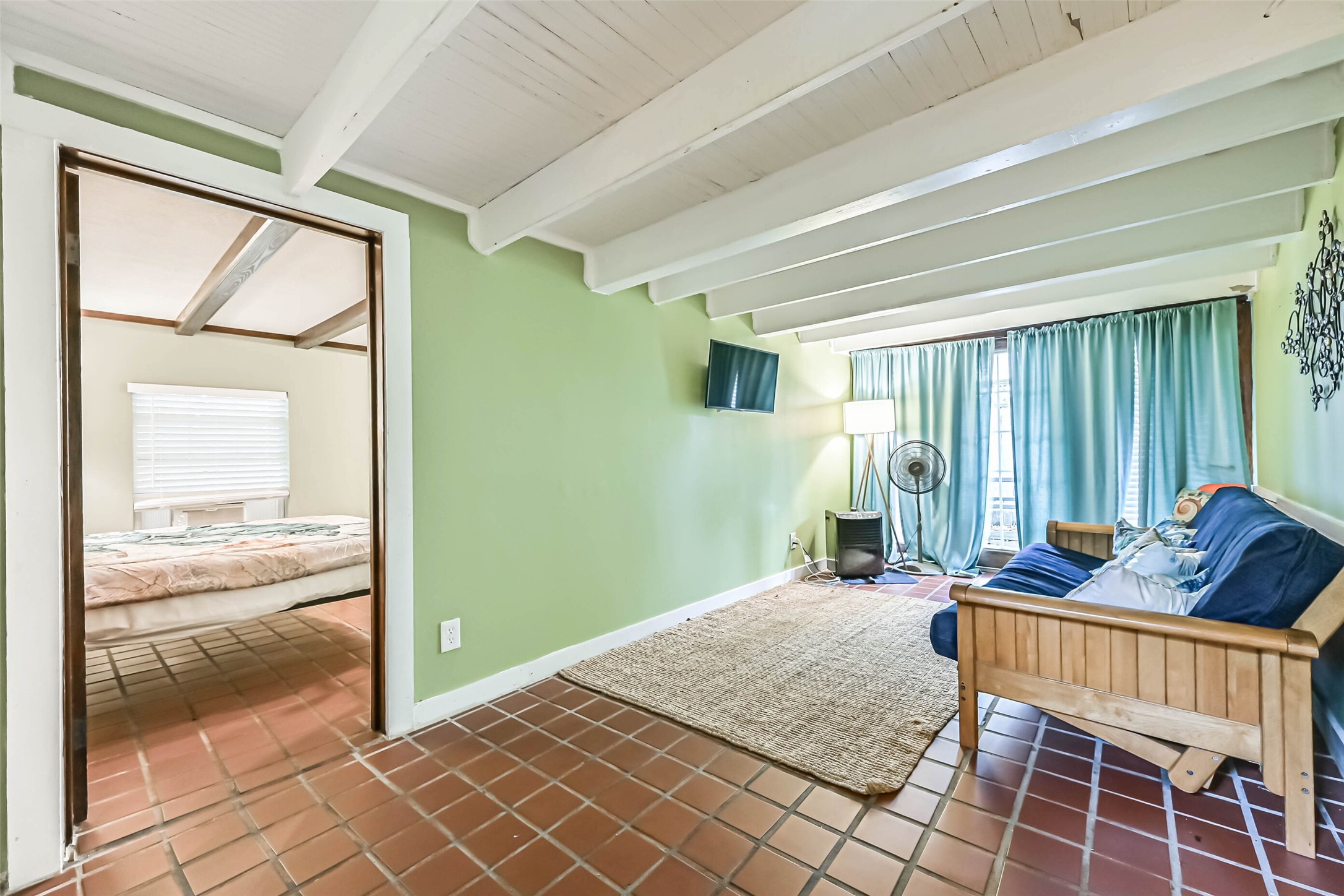 Bright windows and an inviting seating area create a relaxing space to enjoy quiet mornings or casual gatherings.