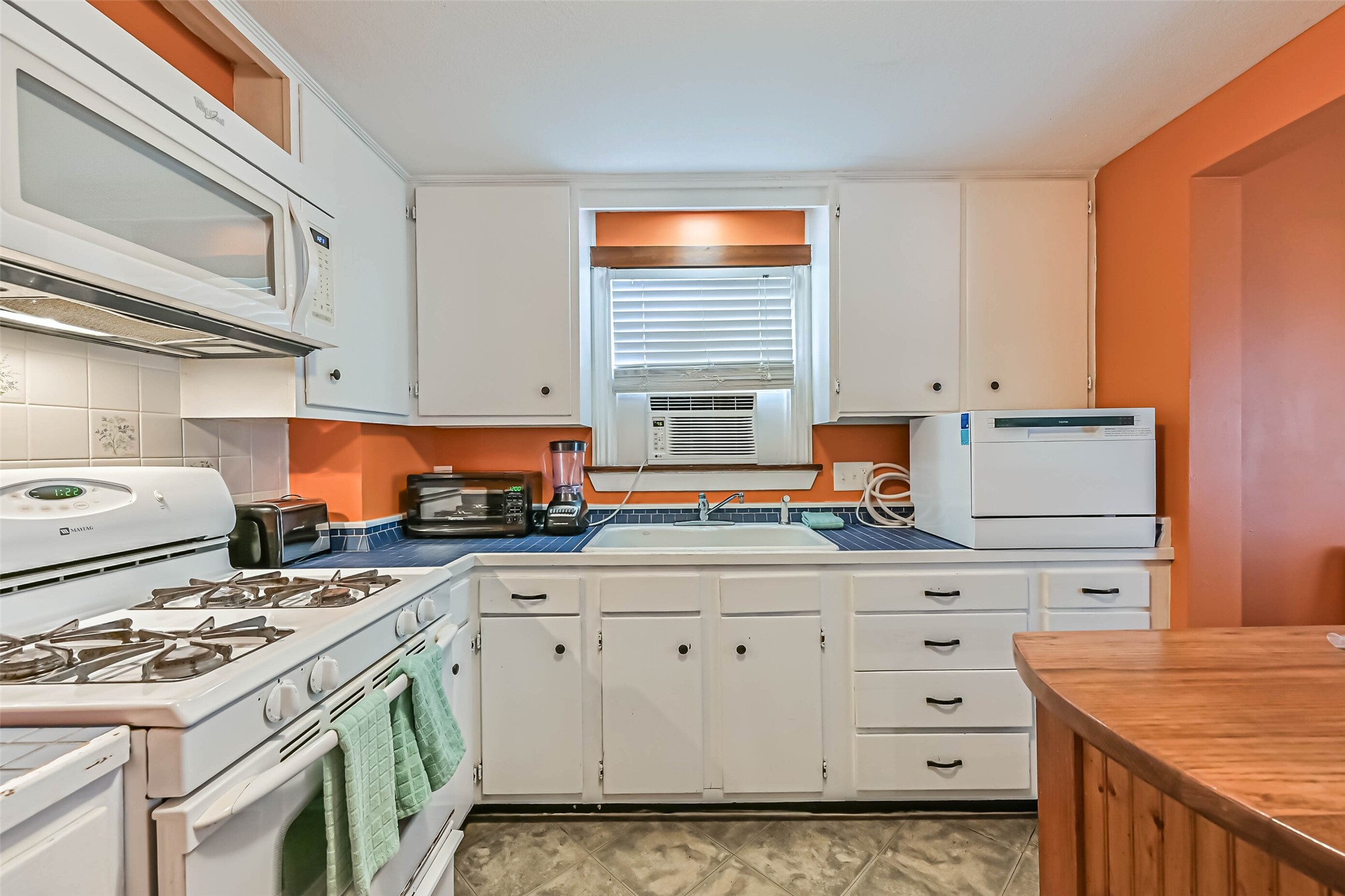A welcoming kitchen with white cabinetry and a center island, offering a practical space for cooking and gathering.