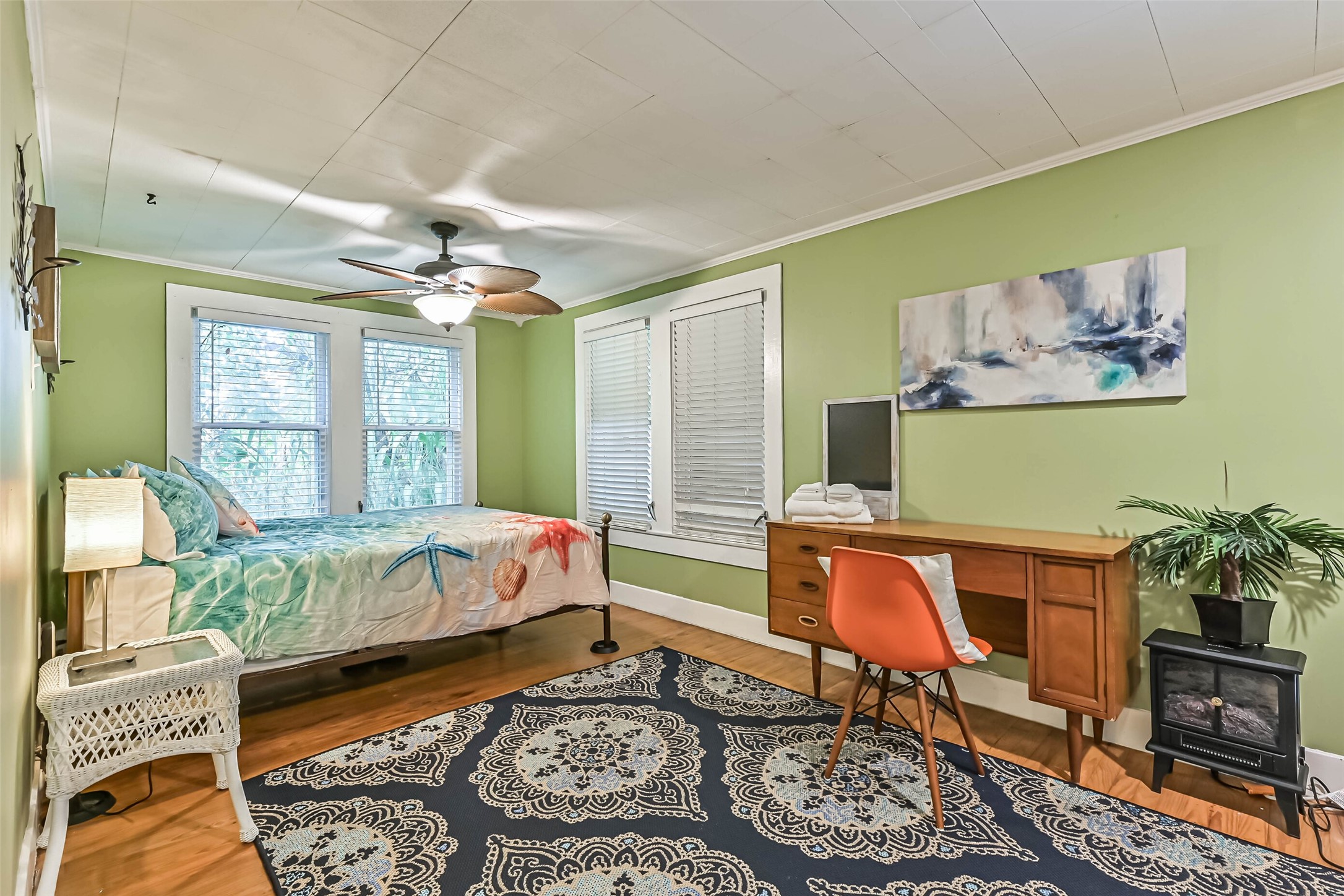 A cozy bedroom with inviting bedding and natural light, offering a comfortable place to unwind.