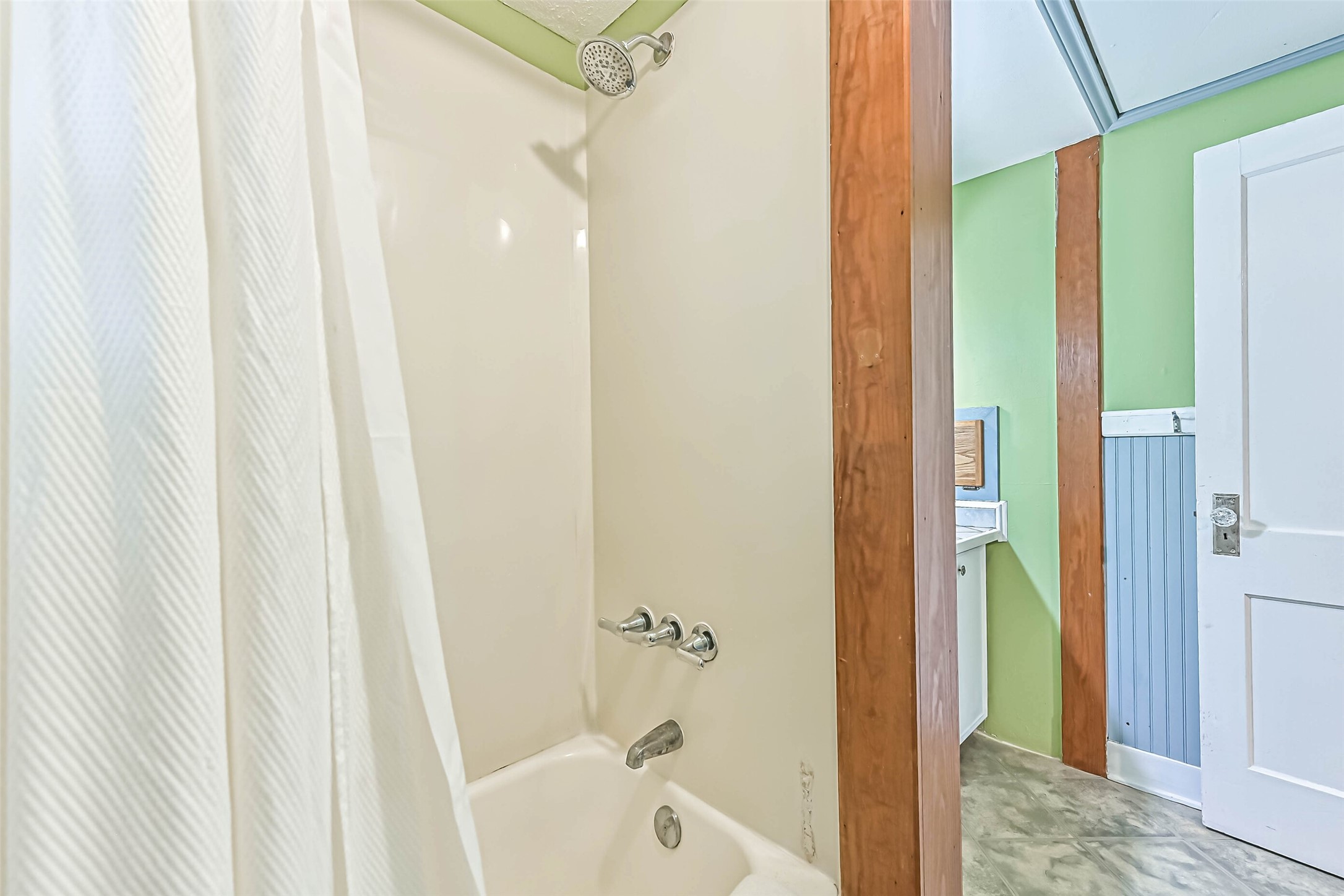 A private shower area with textured glass, creating a simple and functional space to refresh and unwind.