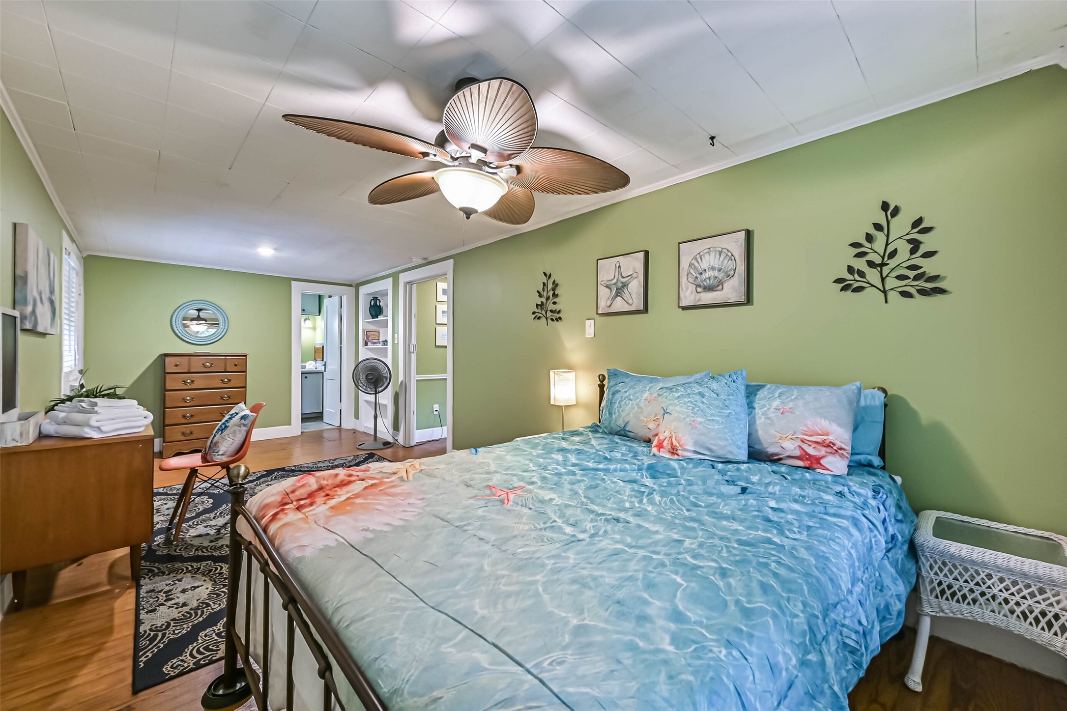 A comfortable bedroom with a ceiling fan and natural light, offering a peaceful place to rest and recharge.