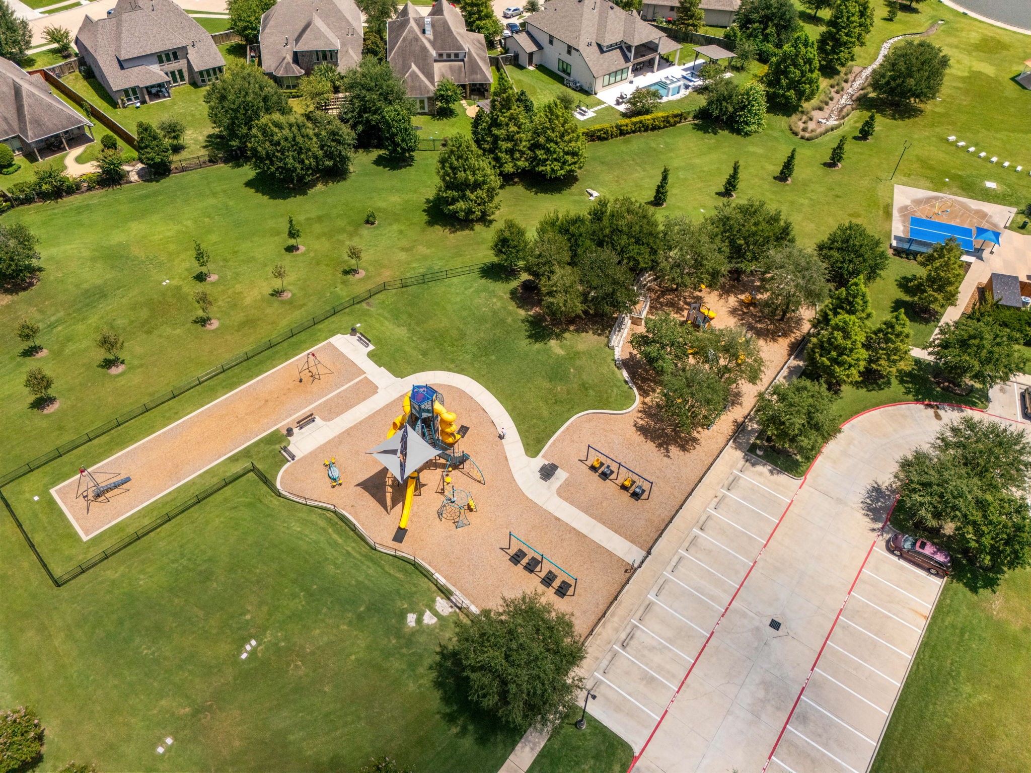 Alianas recreation areas offer even more ways to enjoy the outdoors, with playgrounds and sports courts providing dedicated spaces for play and activity. Expansive lawns surrounding the amenities add to the communitys spacious, park-like setting.