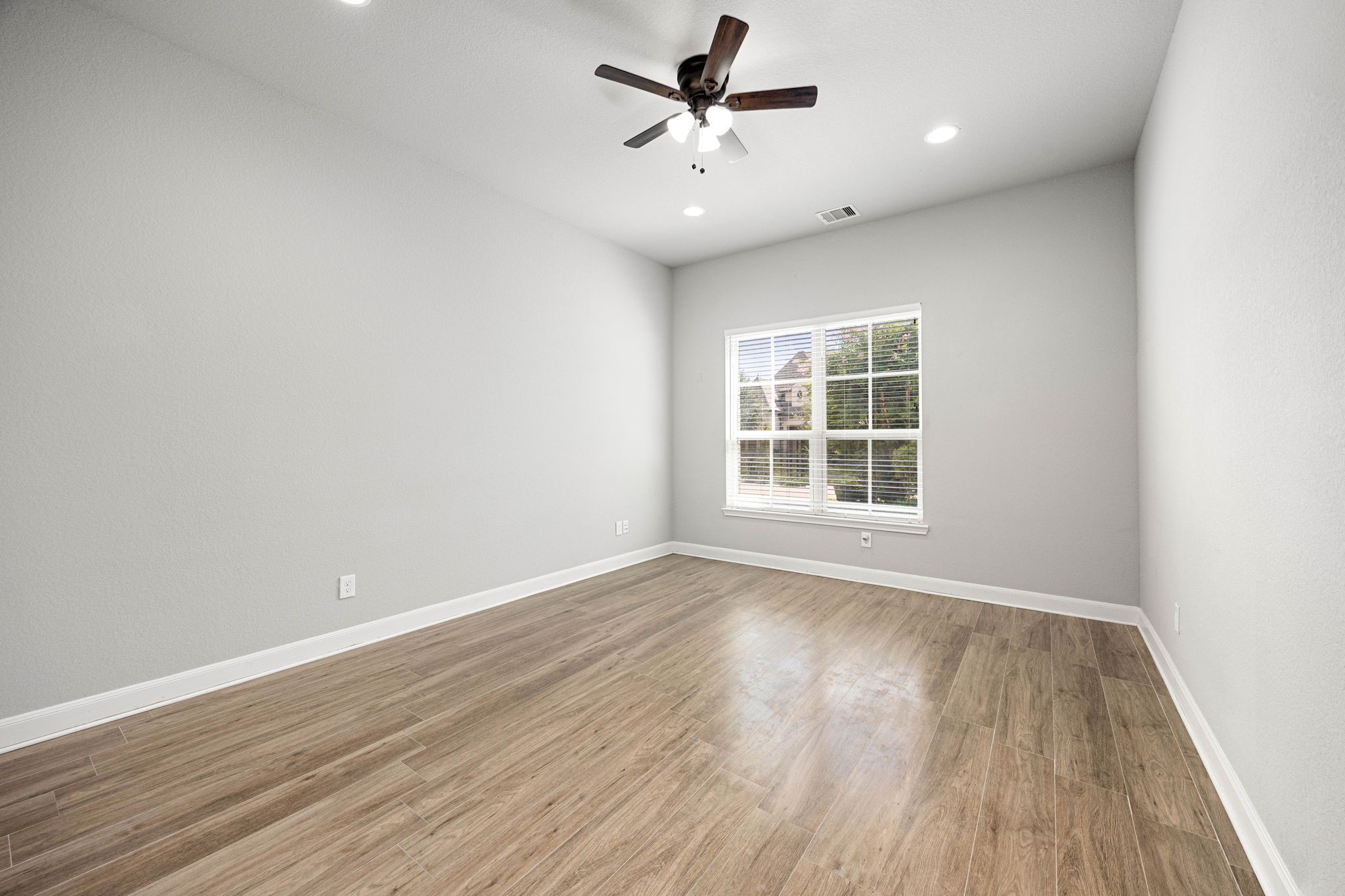 Bright and inviting home office featuring a large window that fills the space with natural light.