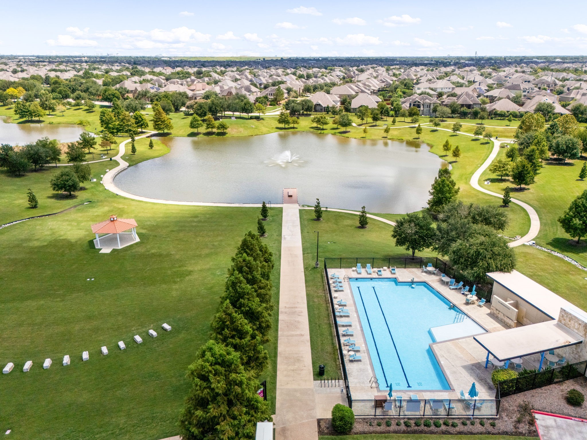 Aliana offers an impressive collection of outdoor amenities, with community pools, lakes, parks and an extensive network of trails and green spaces woven throughout the neighborhood. This aerial view captures just part of the recreational lifestyle available within this Richmond master-planned community.