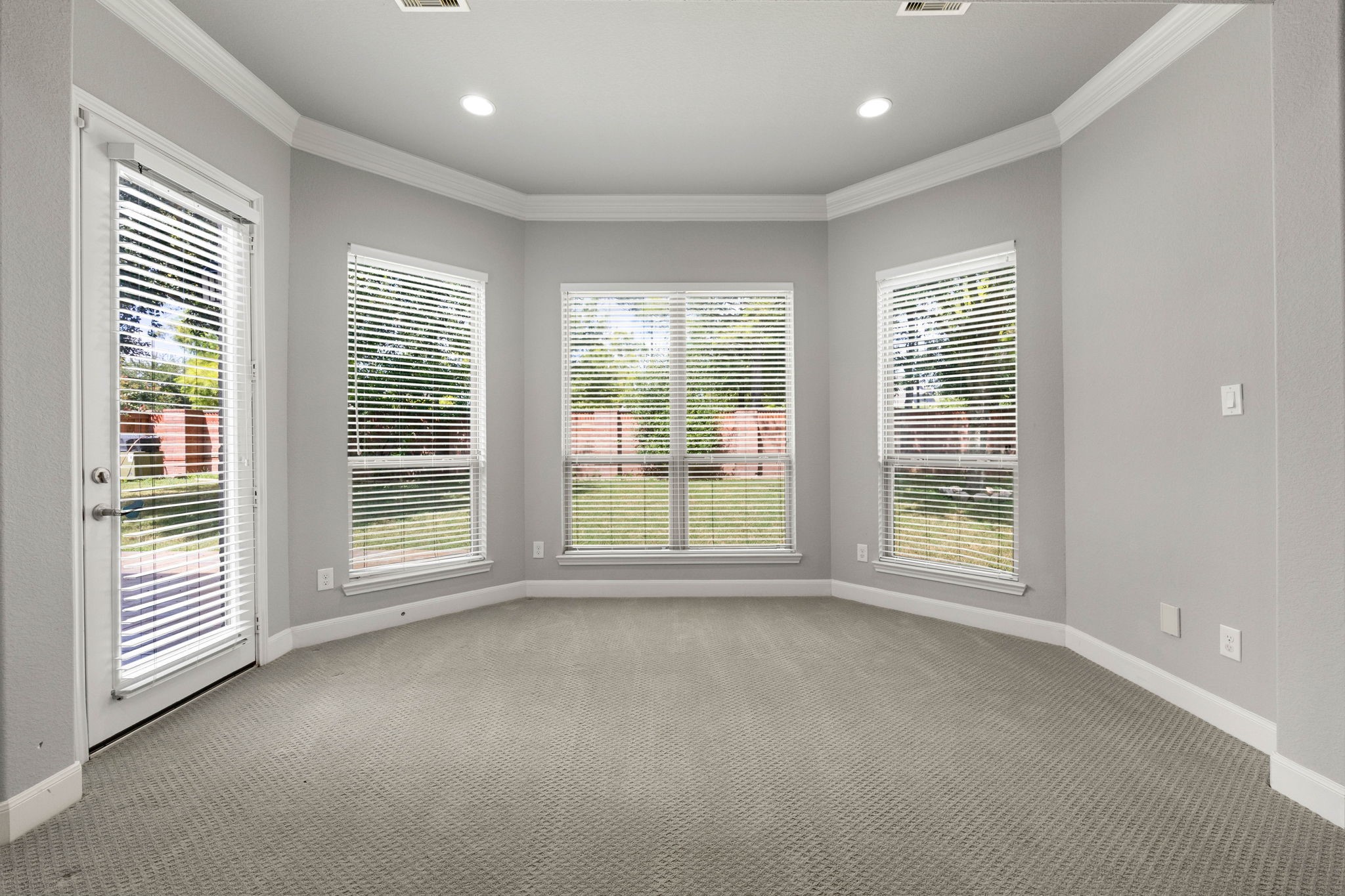 A bay-window nook within the primary suite brings in abundant natural light, offering a cozy spot for reading or relaxing just steps from the bedroom.