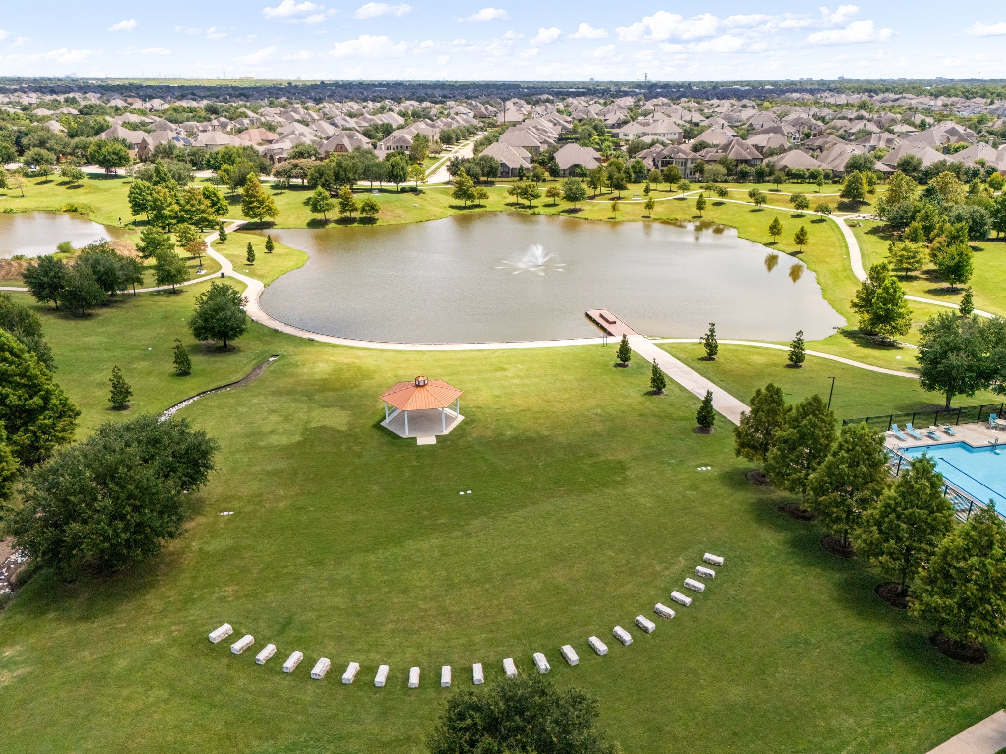 A sweeping aerial perspective showcases the scale of Aliana, where thoughtfully designed residential enclaves surround inviting community gathering spaces. The neighborhoods expansive layout offers a sense of openness while remaining connected to the amenities that make Aliana such a sought-after Richmond community.