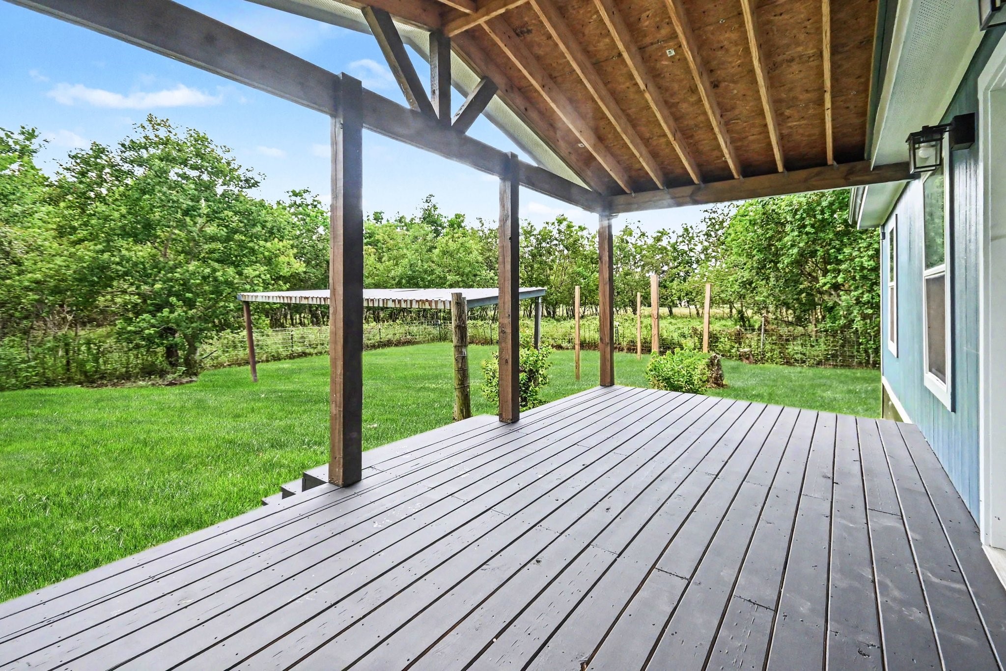 Spacious back porch has acreage view