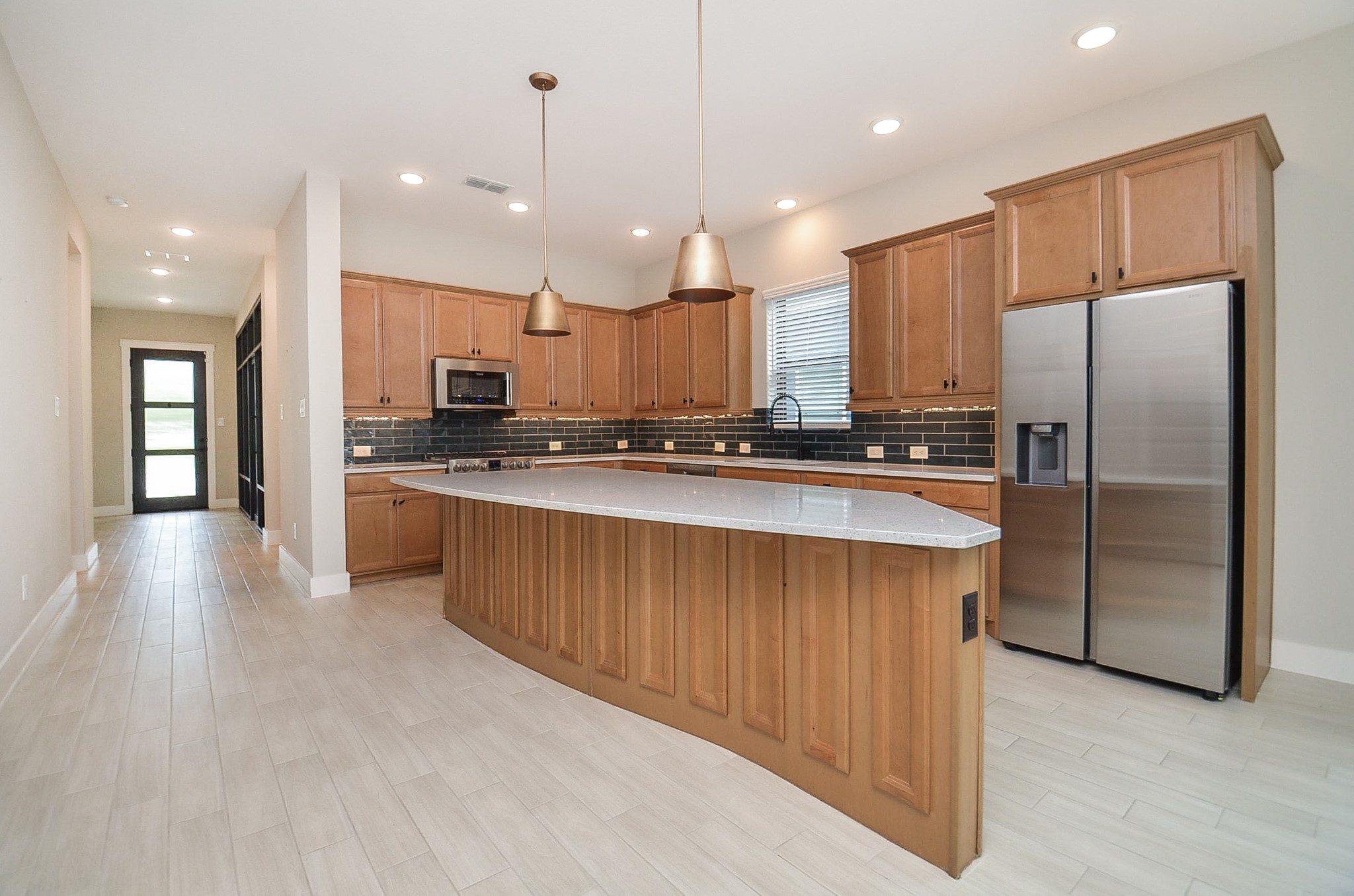 Oversized island creates a natural hub for casual dining, meal prep and conversation.