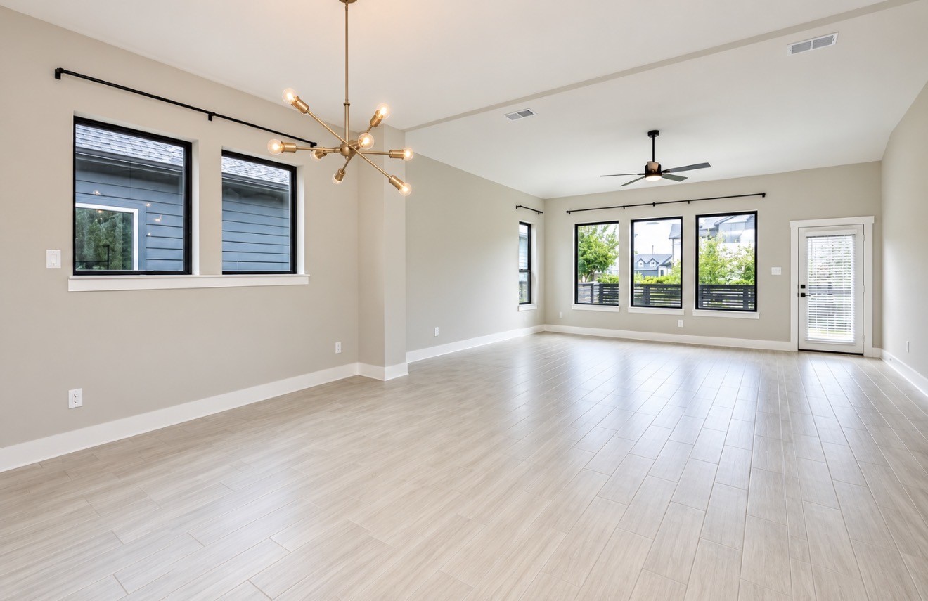 Spacious open-concept living area/dinning area filled with natural light.