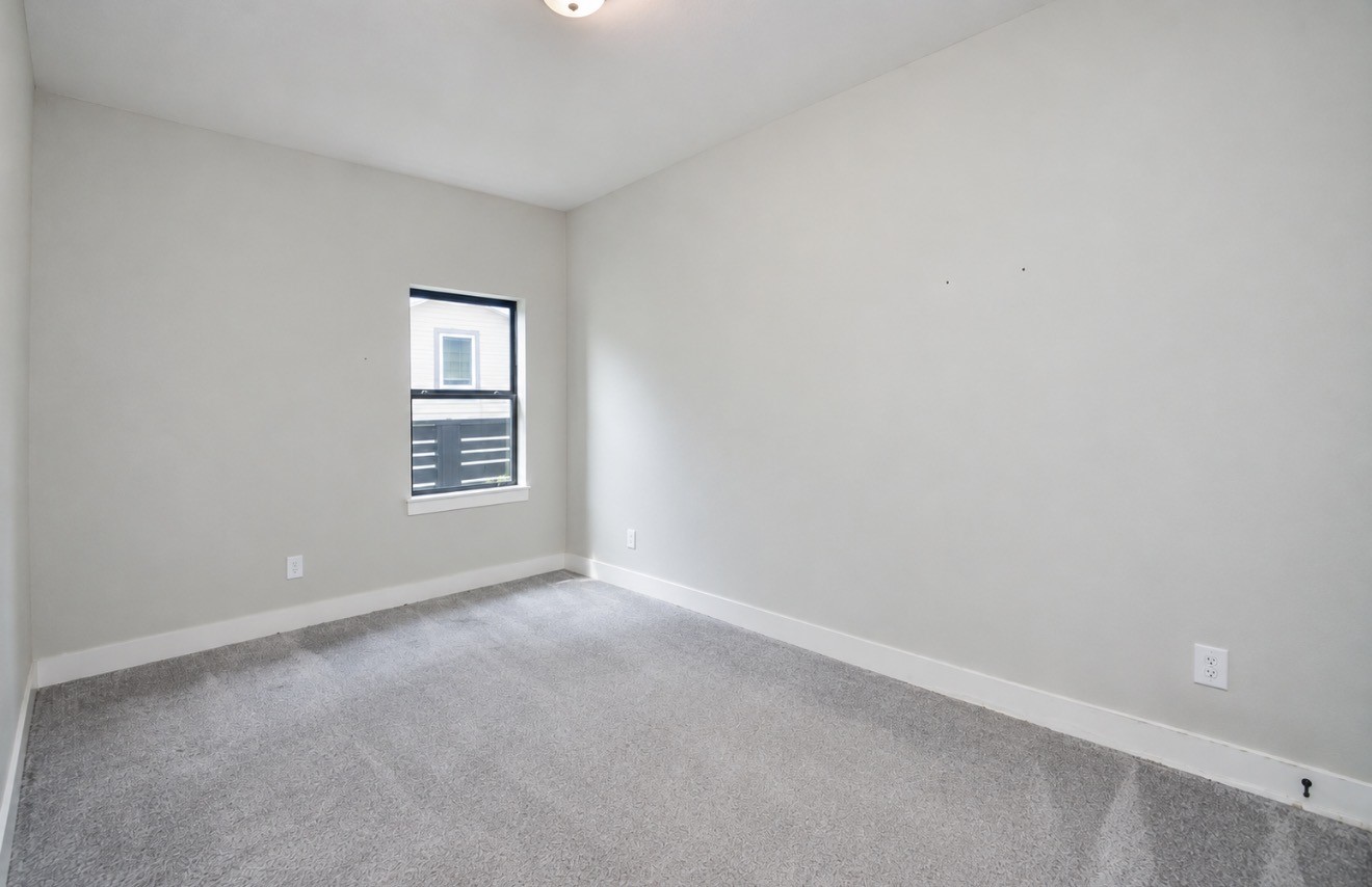 Comfortable secondary bedroom combines neutral finishes, natural light and flexible dimensions.