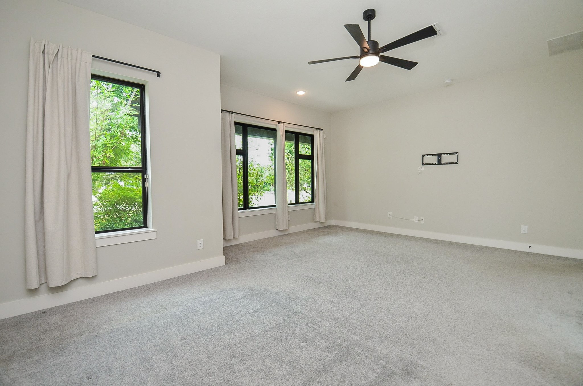 High ceilings and oversized windows enhance the primary suites airy, relaxing atmosphere.