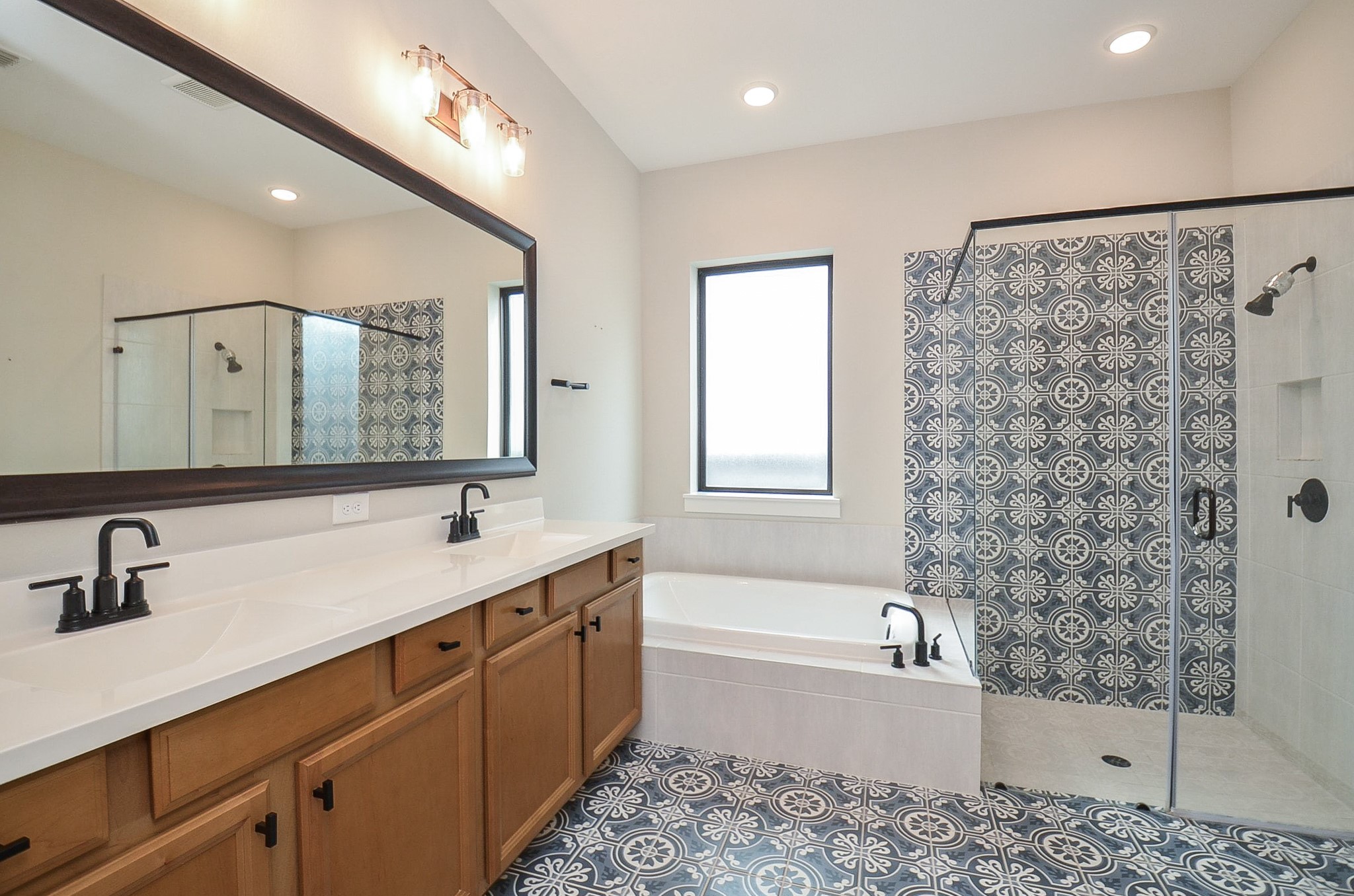 Primary bath offers an extended vanity, ample counter space and a clean, timeless aesthetic.