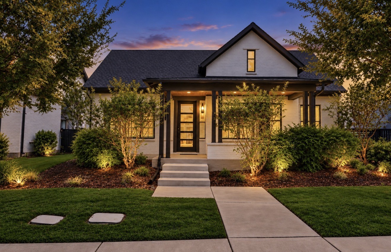Twilight view showcases the distinctive architecture of this David Weekley home and its warm evening ambiance.