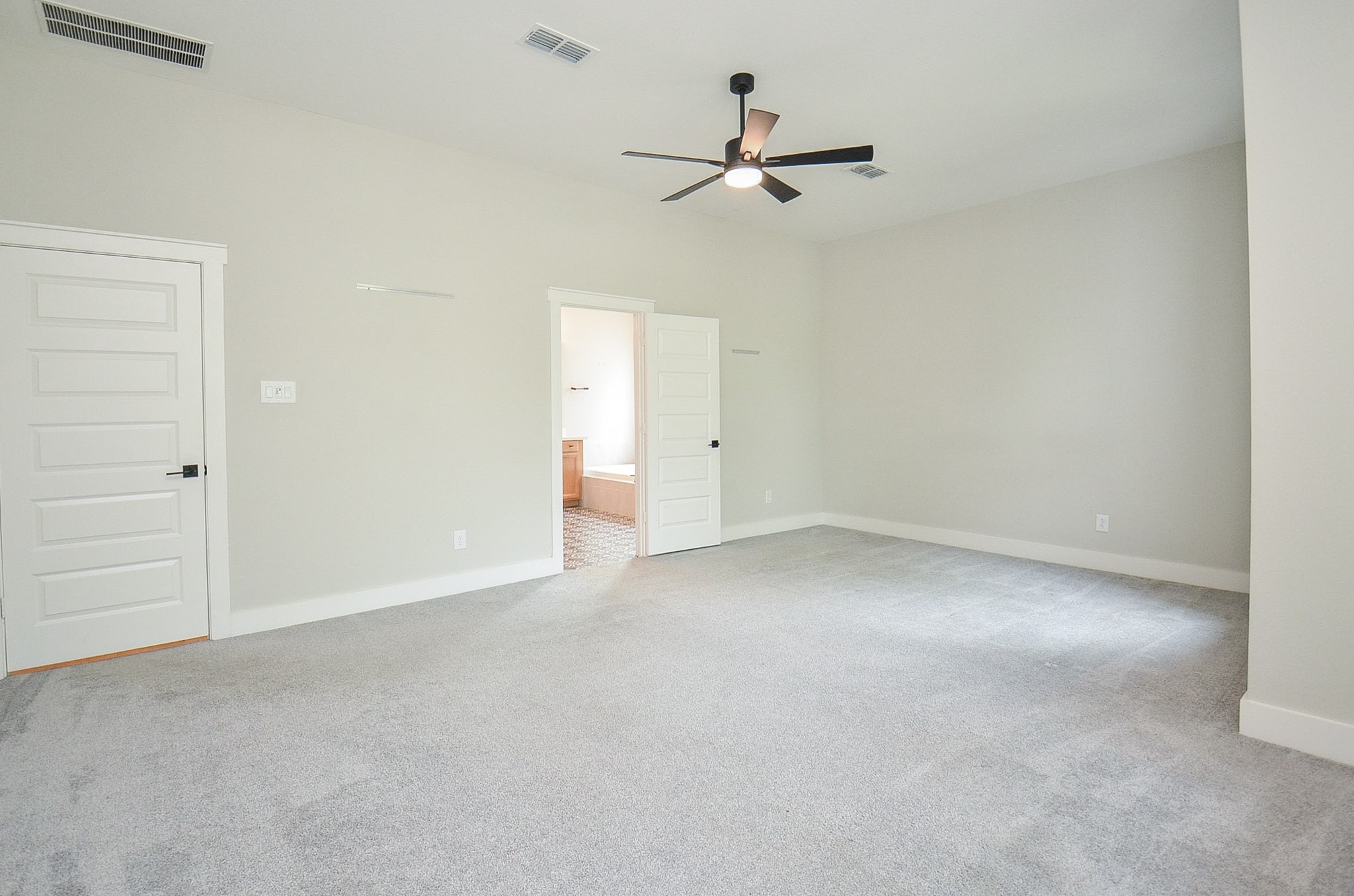 Another view of the owners retreat showcases its impressive scale and flexible furniture placement.