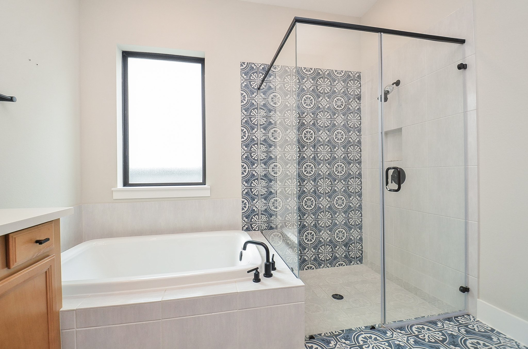 Spa-inspired bathing area features a soaking tub and separate glass-enclosed shower.