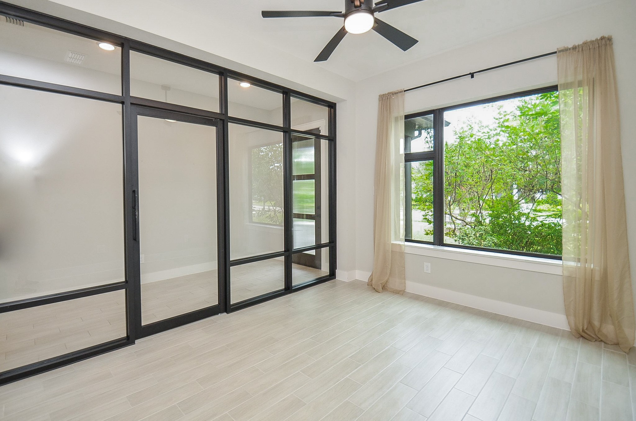 Sun-filled flex room offers versatile space for a home office, lounge or creative retreat.