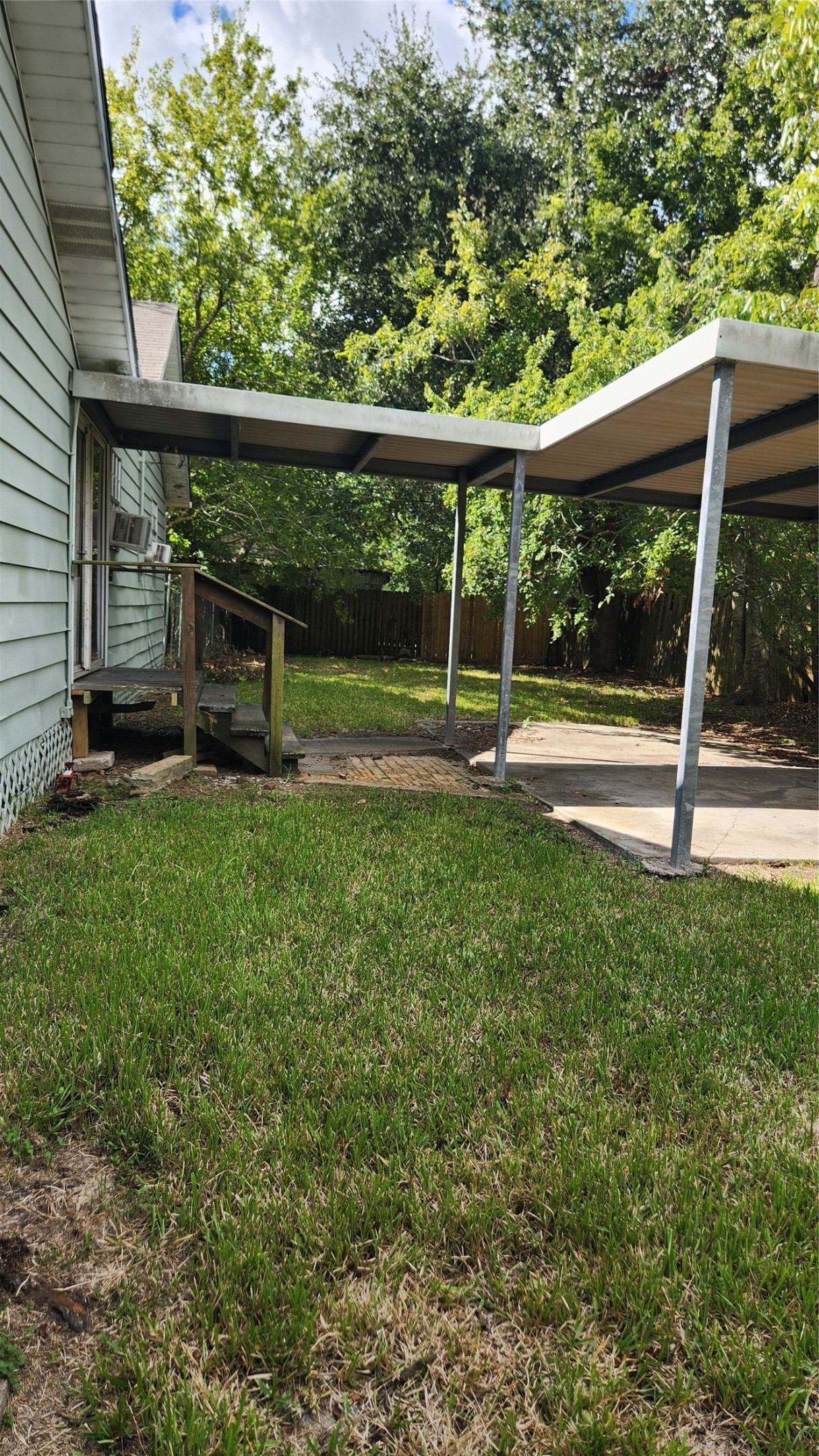 covered porch with access via back patio.