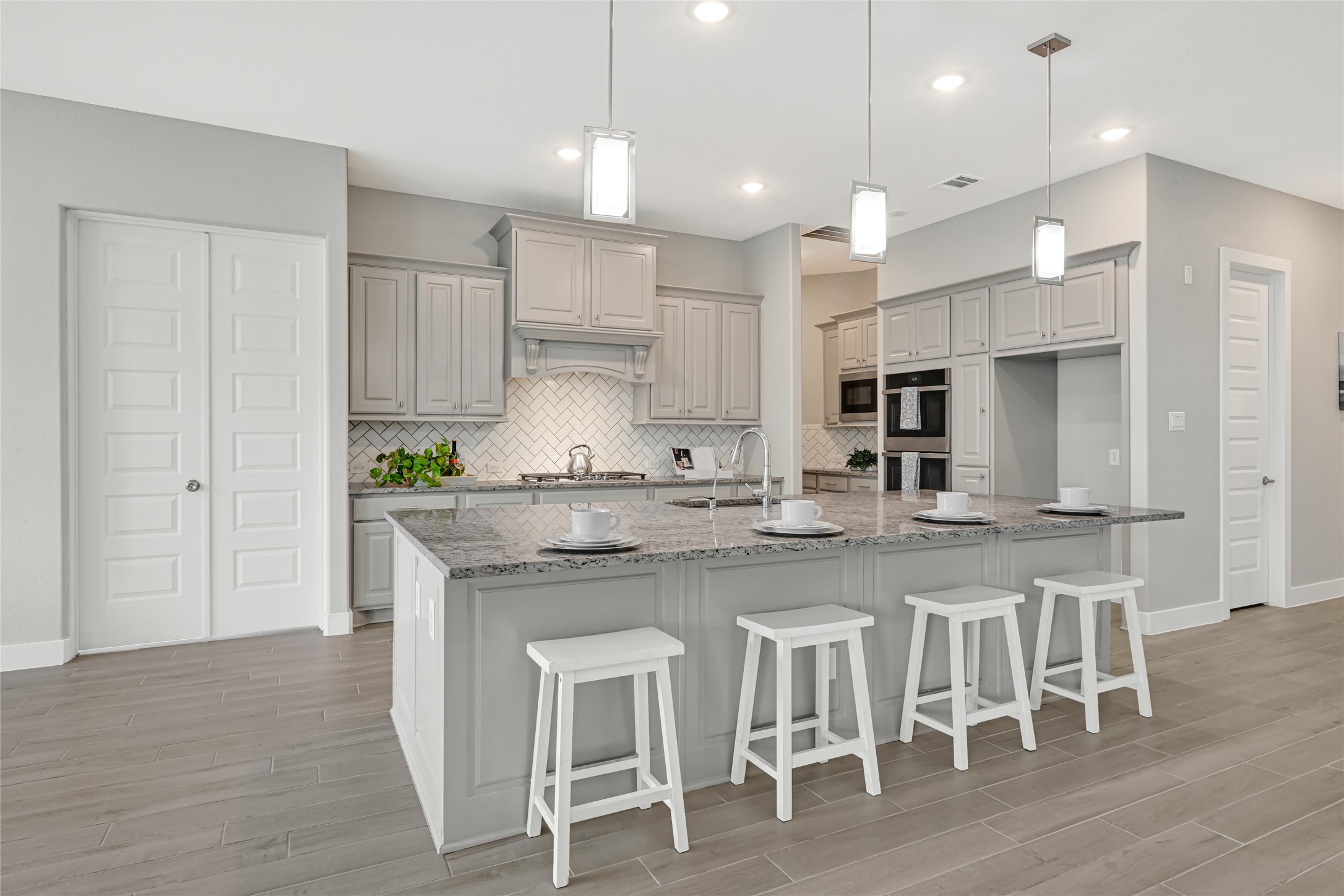 Gourmet main kitchen with large island, ample cabinetry , Upgraded double ovens open layout, Coffee Nook on the side