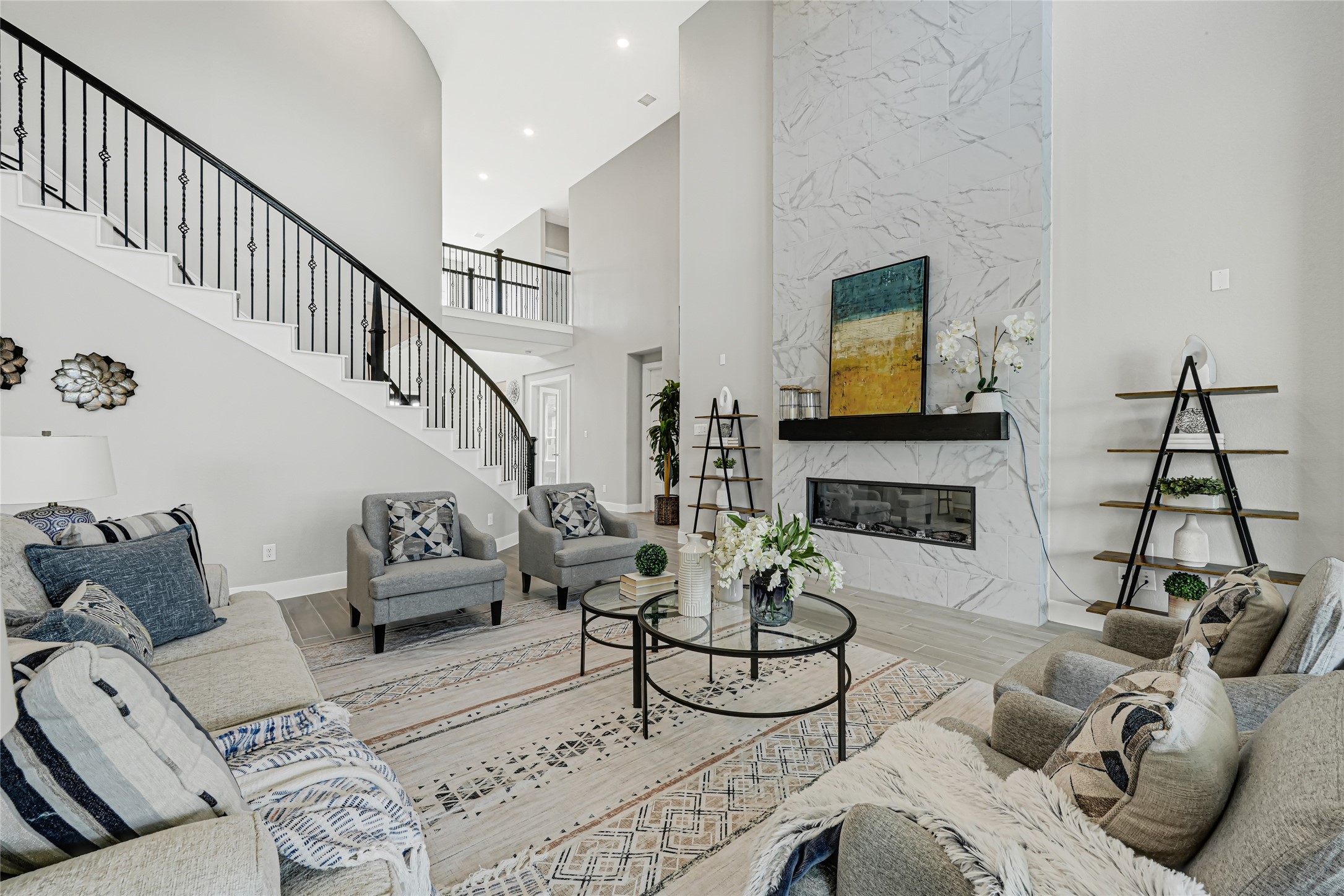 Bright open-concept living area with soaring ceilings, Upgraded Fireplace  and elegant finishes.