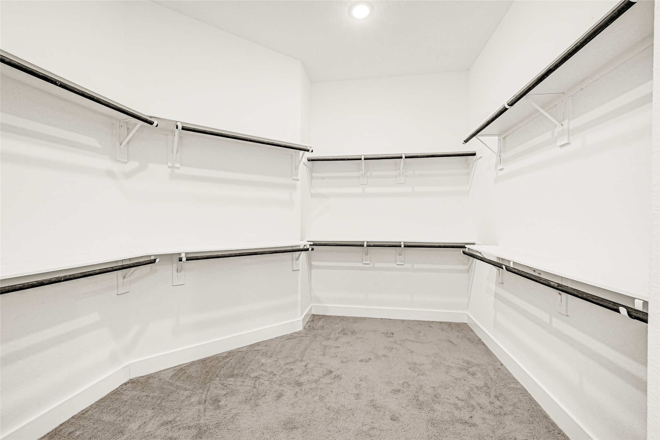 Spacious walk-in closet with extensive built-in storage.