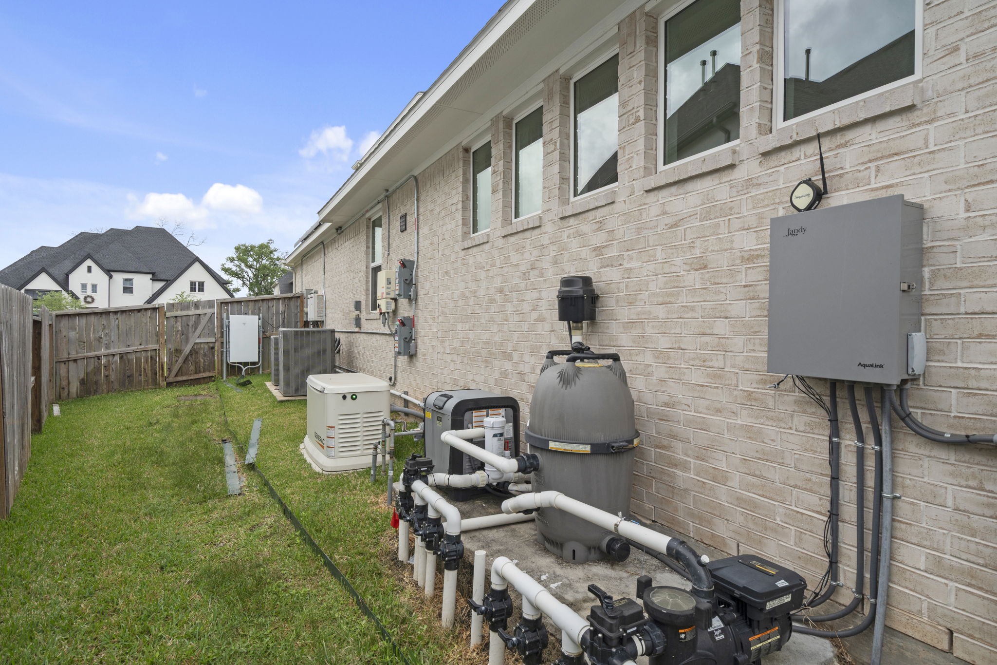 Huge side yard  with Electric generator and utility equipment supporting the home's energy efficiency.
