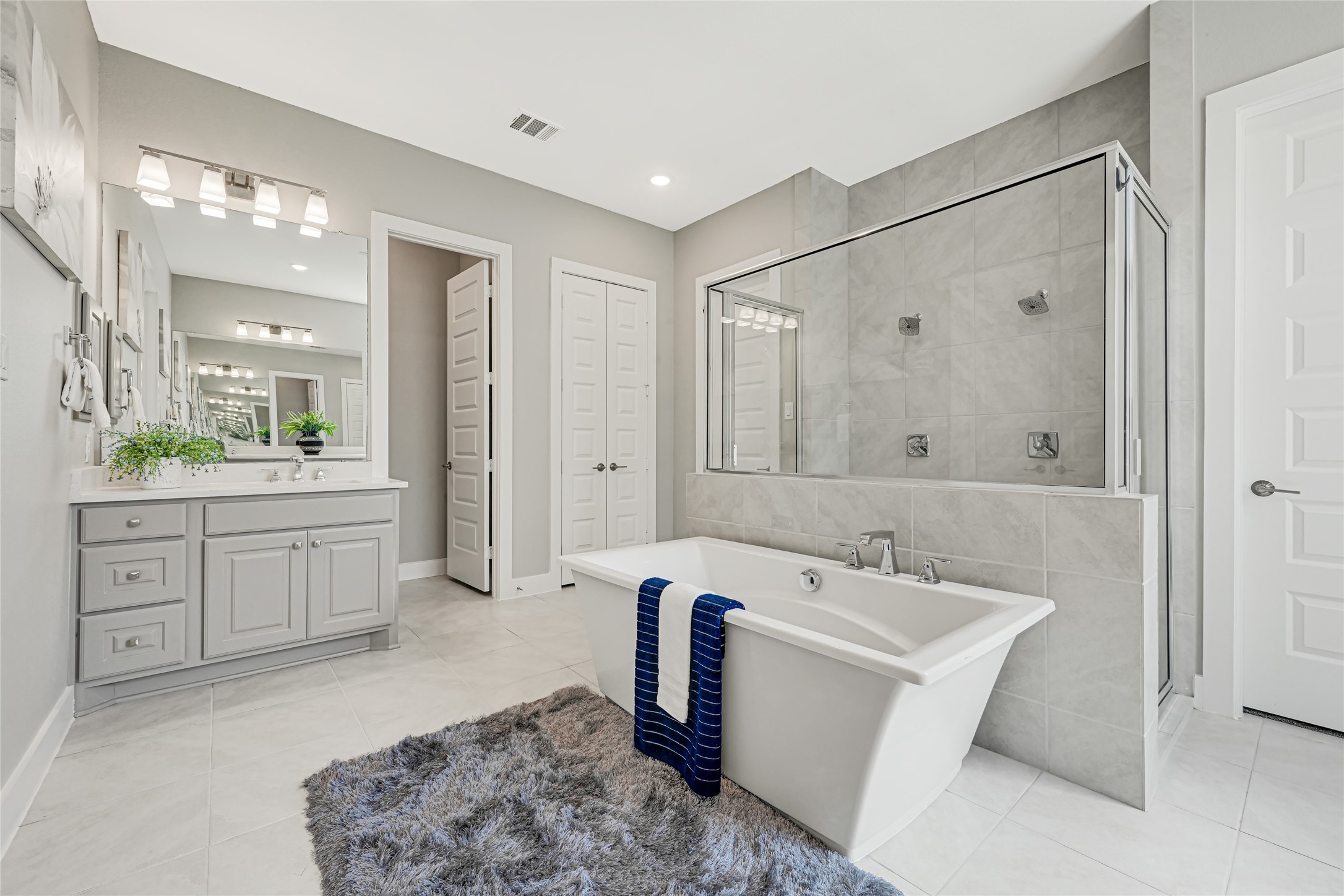 Spa-like primary bath featuring a large walk-in shower and elegant finishes.