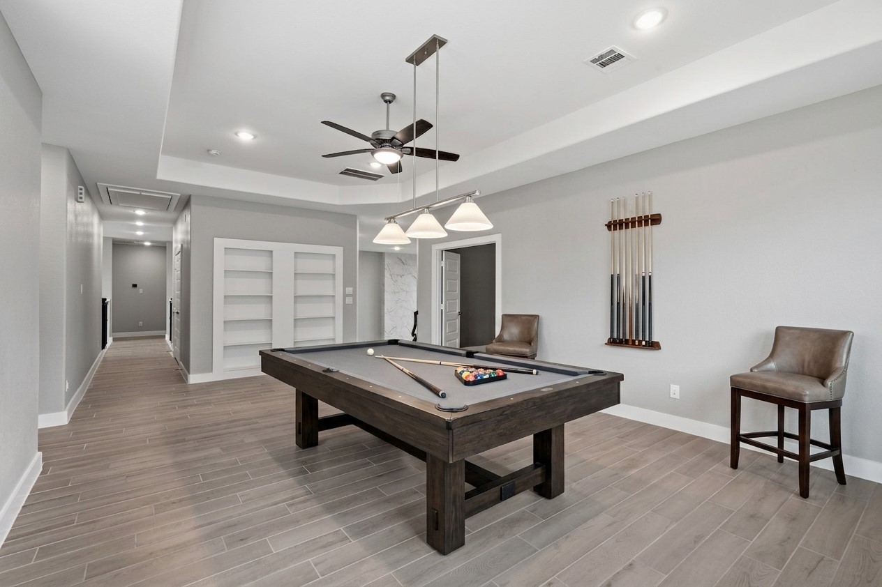 Versatile upstairs living or game room with ample space.