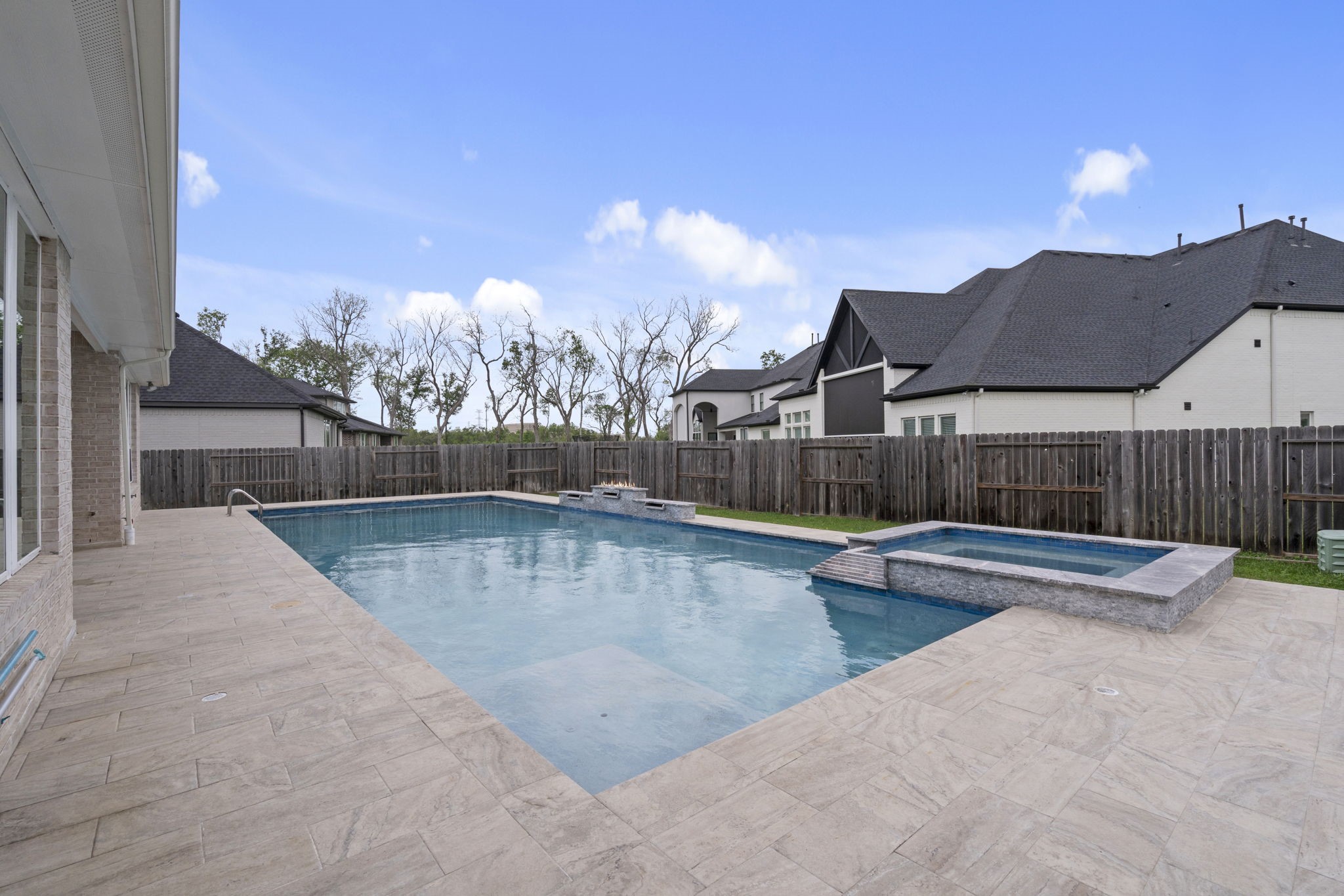 Resort-style pool with spacious deck and outdoor entertaining space.