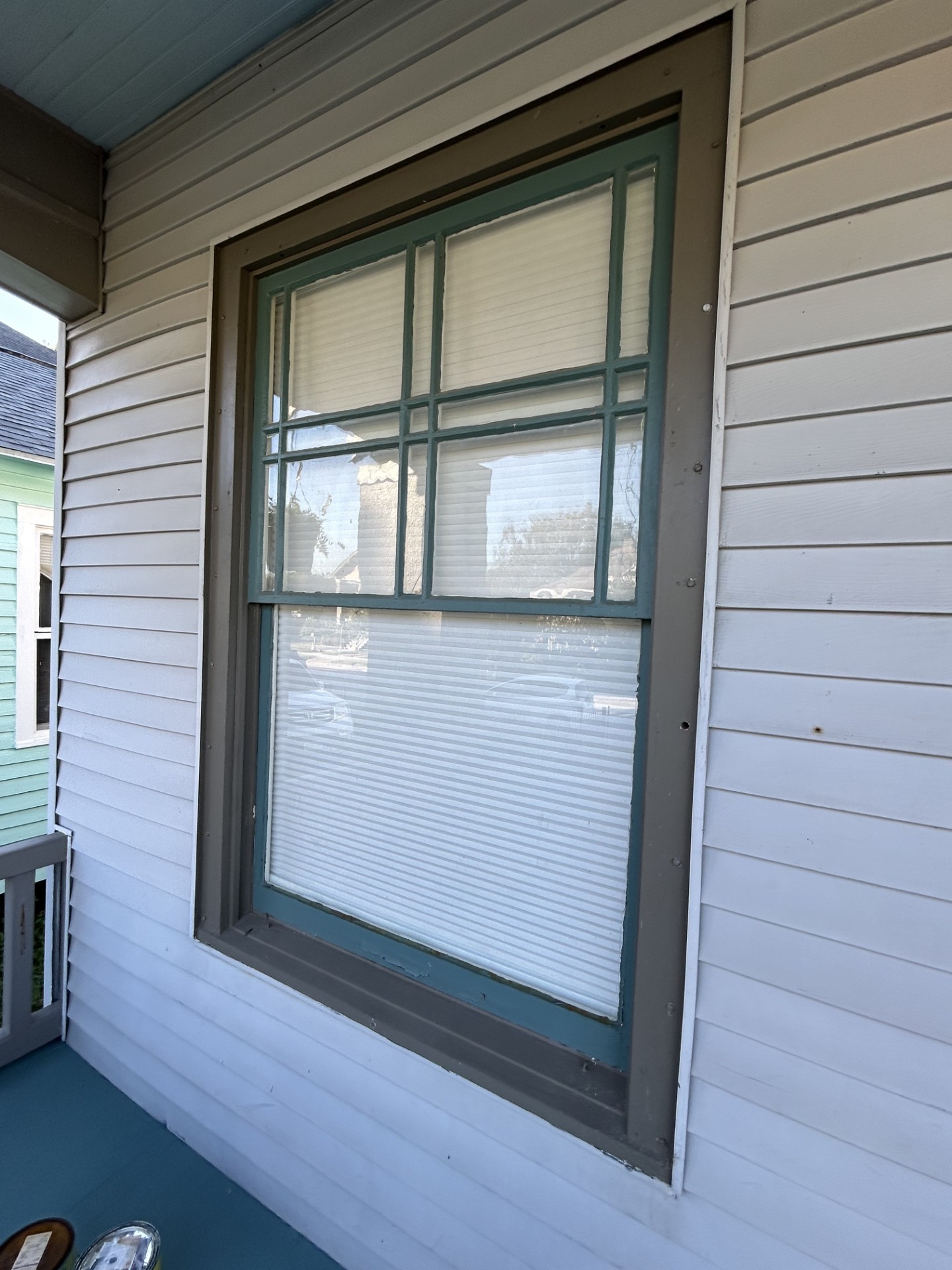 Craftsman-style front window with the detailed upper sash and the lone lower sash.