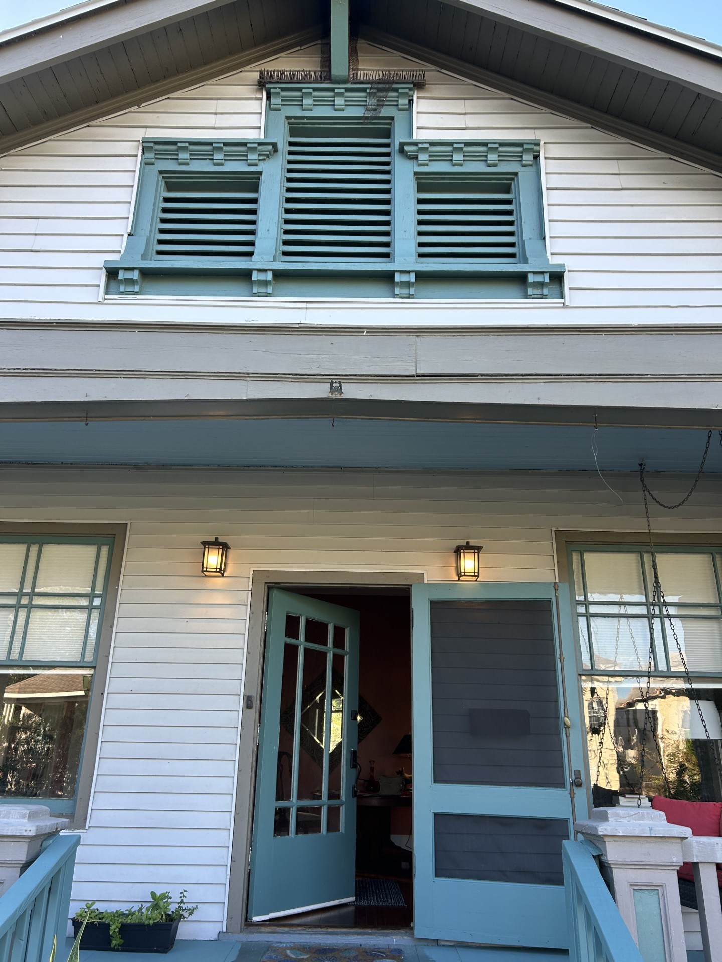Three attic vent windows in a craftsman-style.
